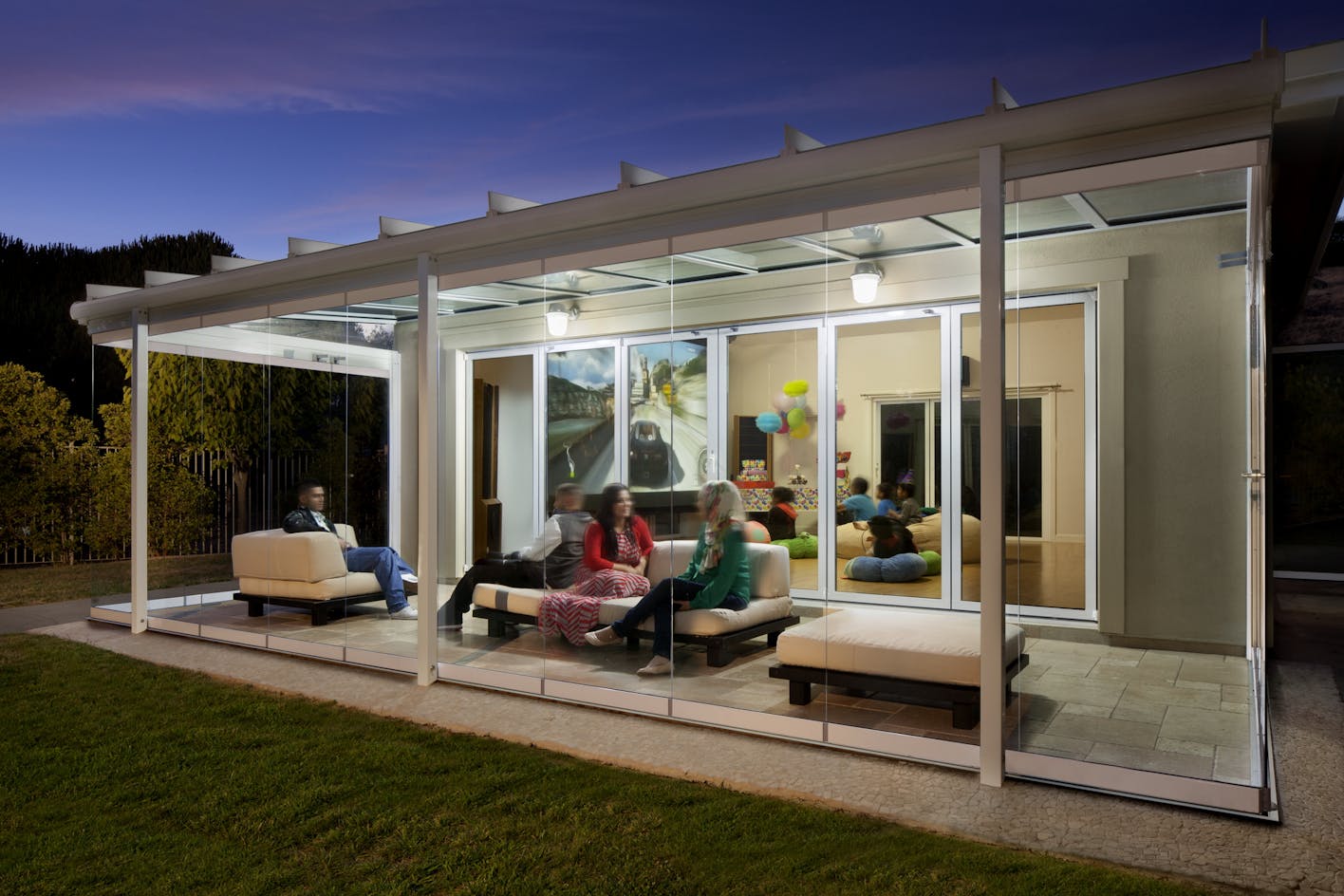 Porch enclosed with folding glass walls for entertaining space year-round.