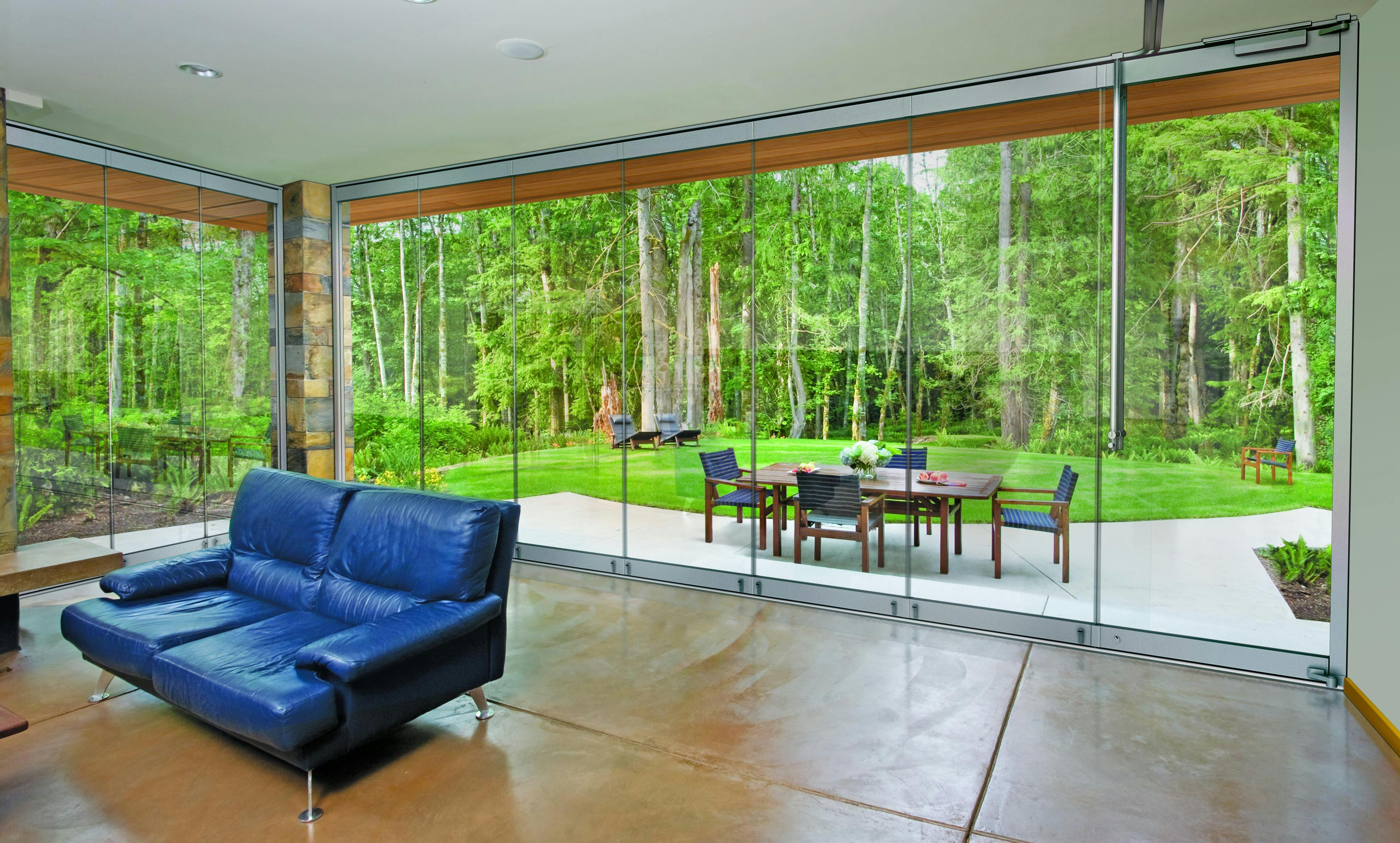 ClimaCLEAR frameless glass walls enclose an indoor/outdoor living space