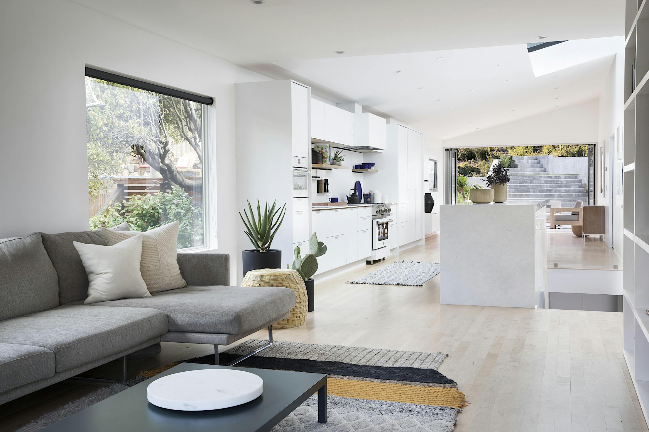 remodeled home with open concept living and opening glass wall