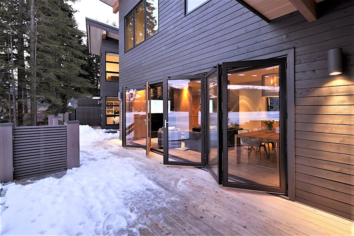 Folding glass walls replace a patio door and perform in harsh weather