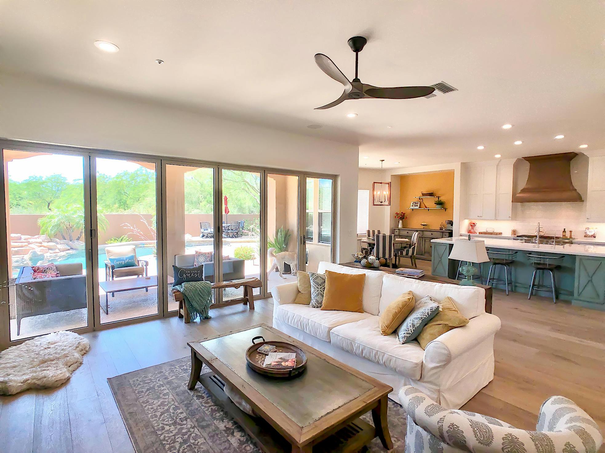 remodeled room with folding glass walls allowing indoor/outdoor lifestyle