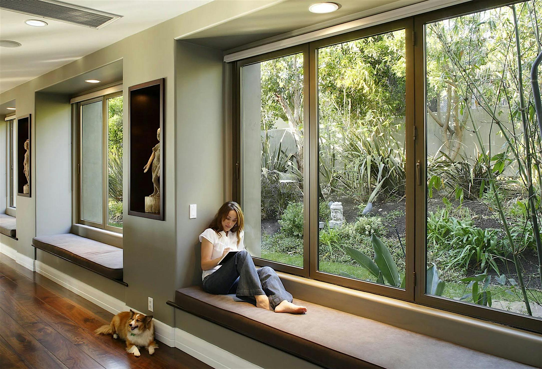 Woman exploring ideas in front of folding glass window