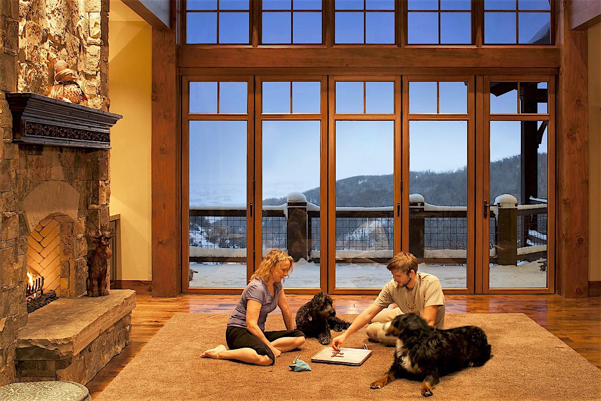 stay safe stay home family playing games in front of folding glass wall