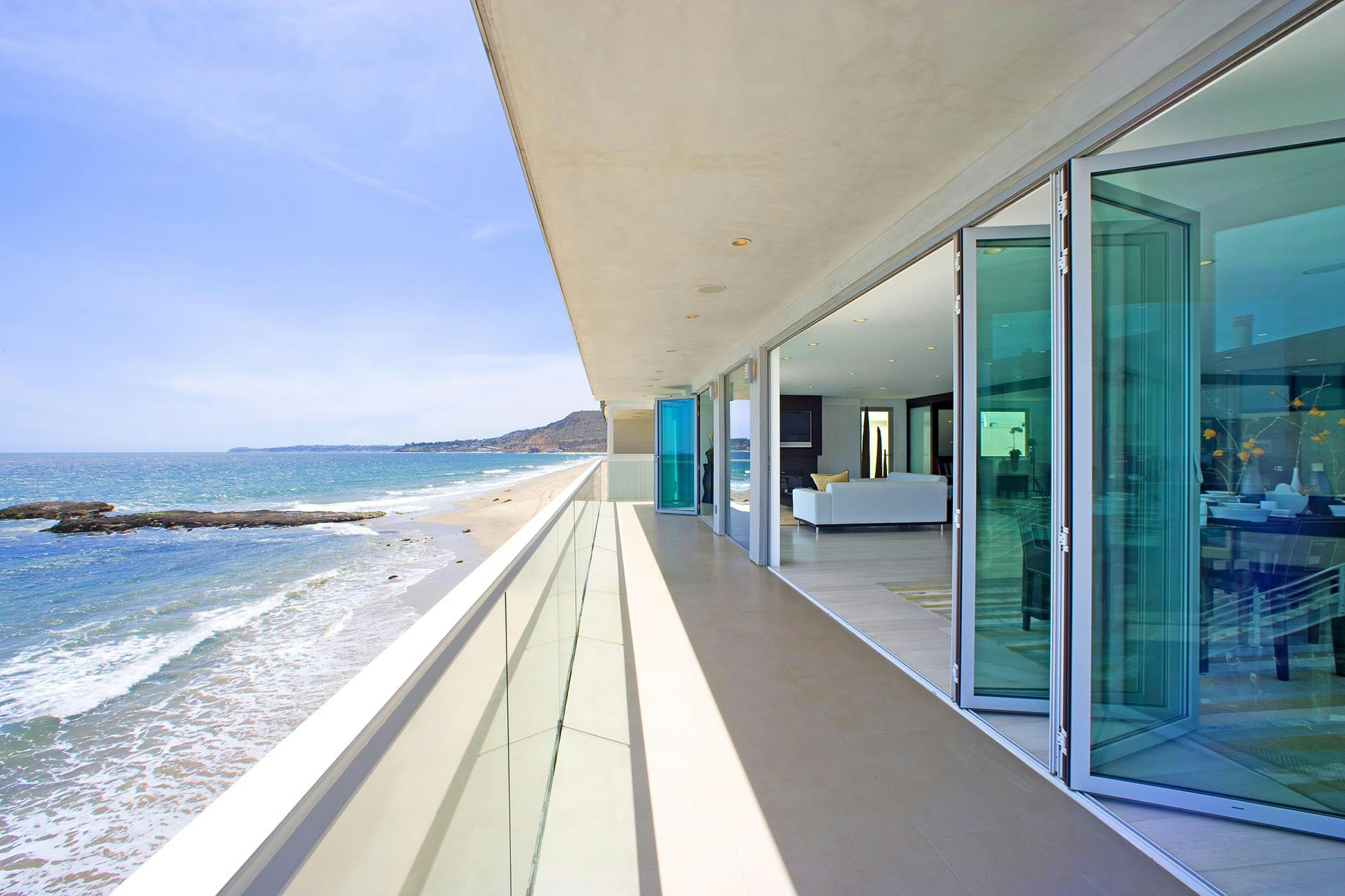 aluminum framed folding glass walls in modern oceanfront home