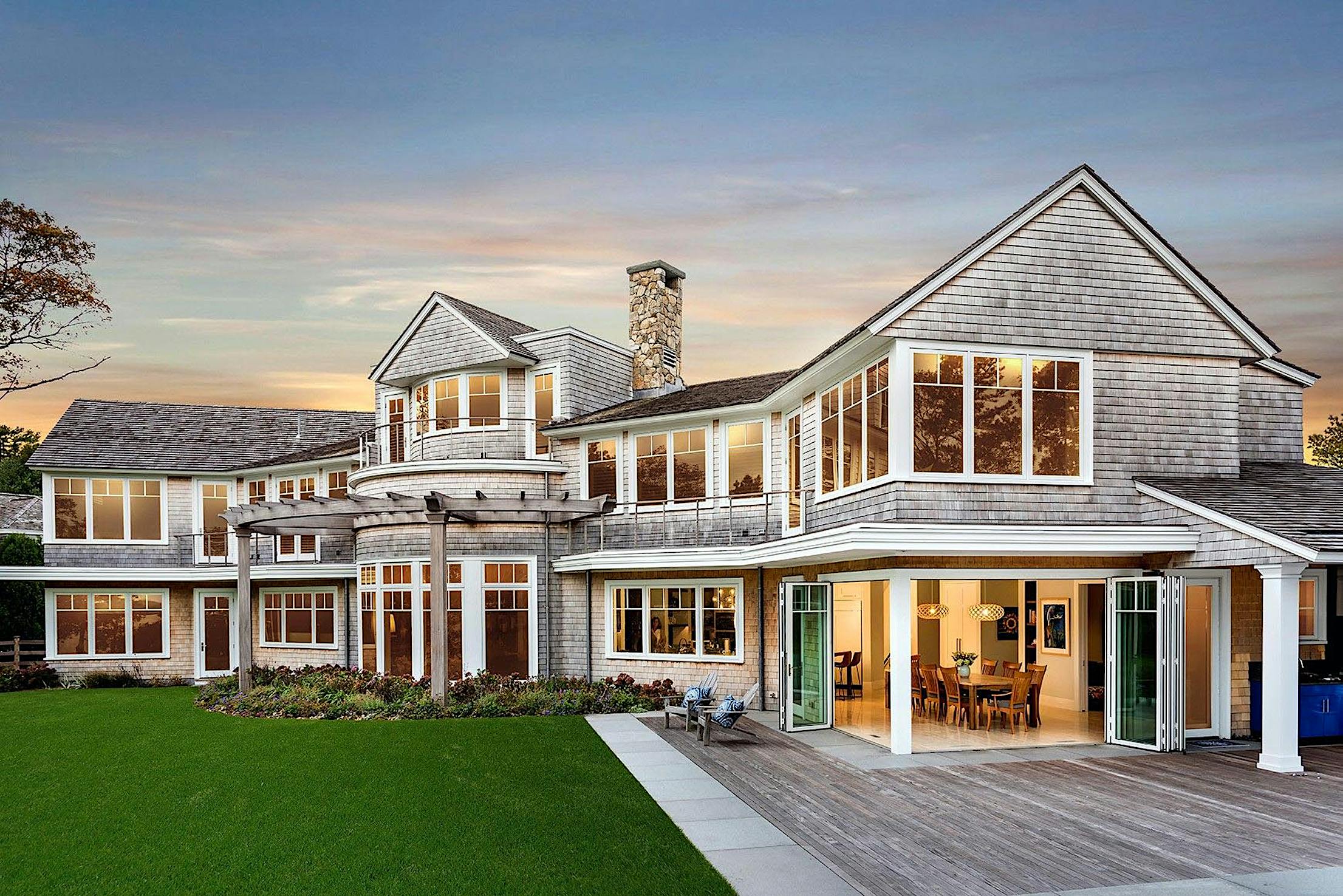folding glass walls in traditional homes creates indoor/outdoor experience