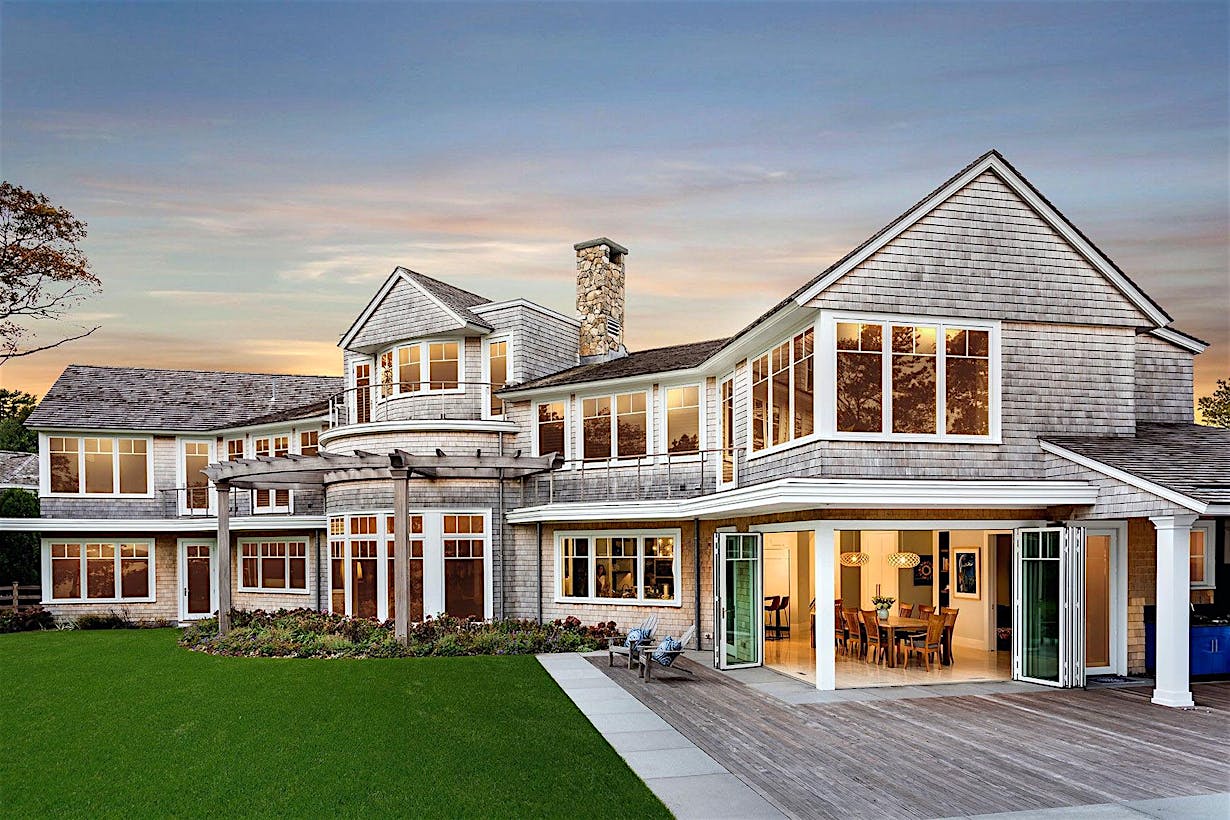 folding glass walls in traditional homes creates indoor/outdoor experience