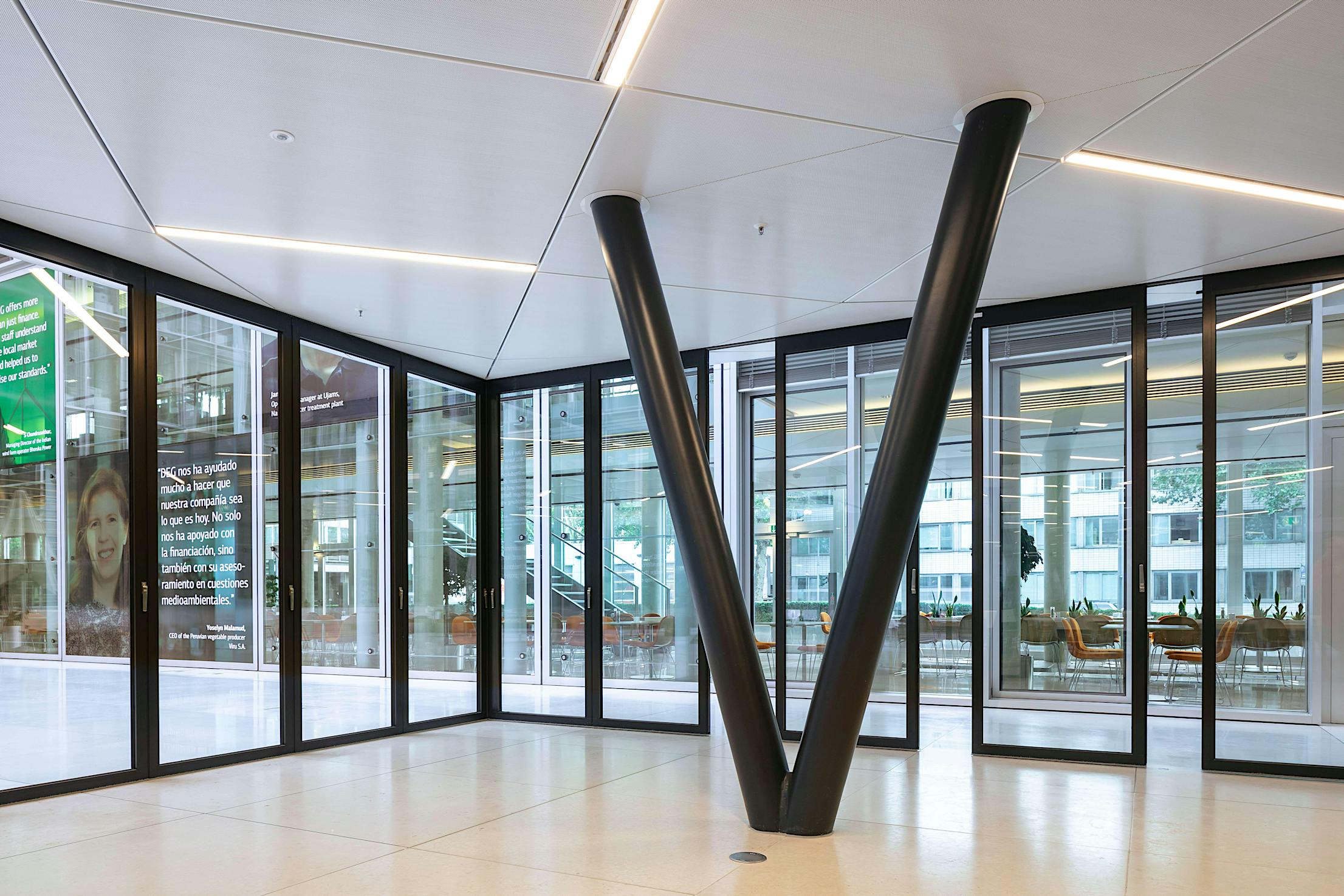 V-shaped structural supports and stacking glass door levitate the conference room above