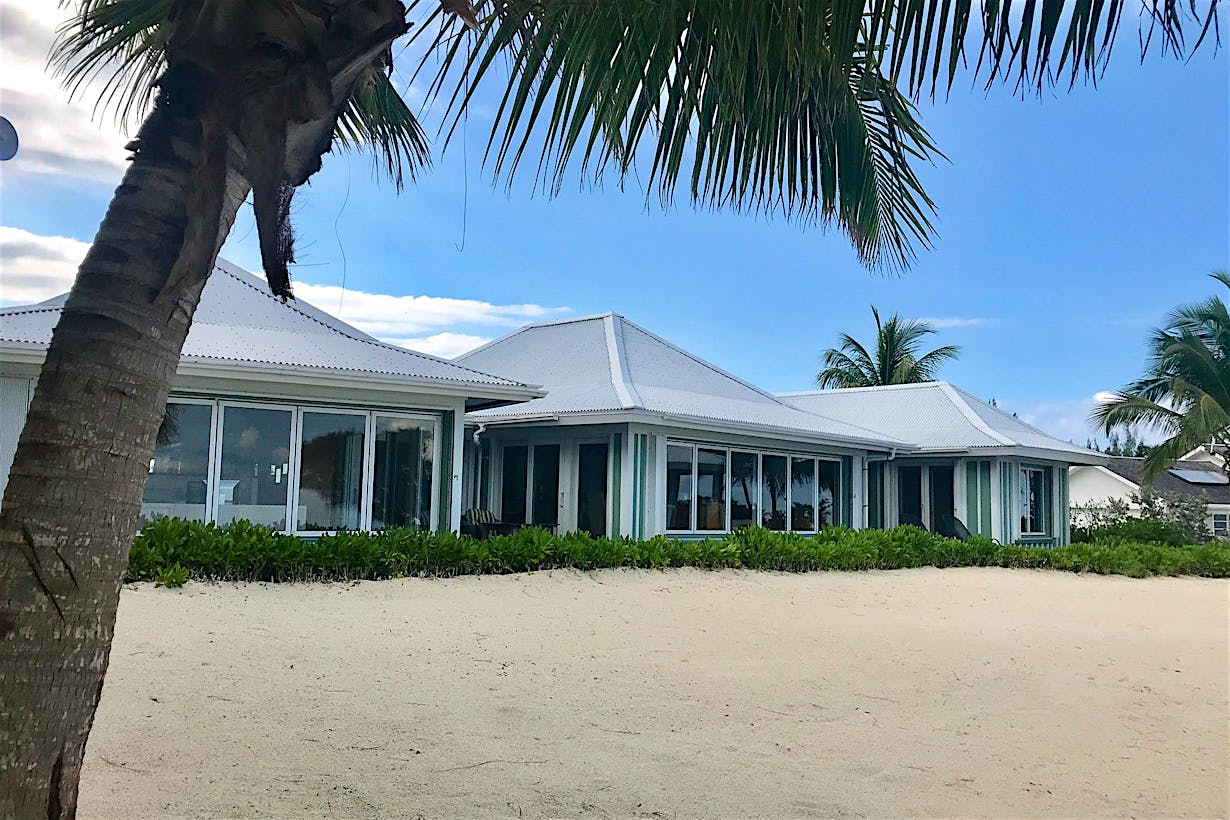 tropical beachfront home with folding glass walls