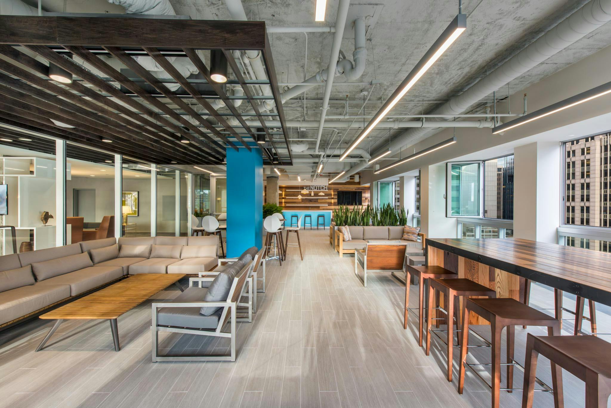 the notch amenities room on the 28th floor with folding glass window walls open for fresh air in high-rise office building