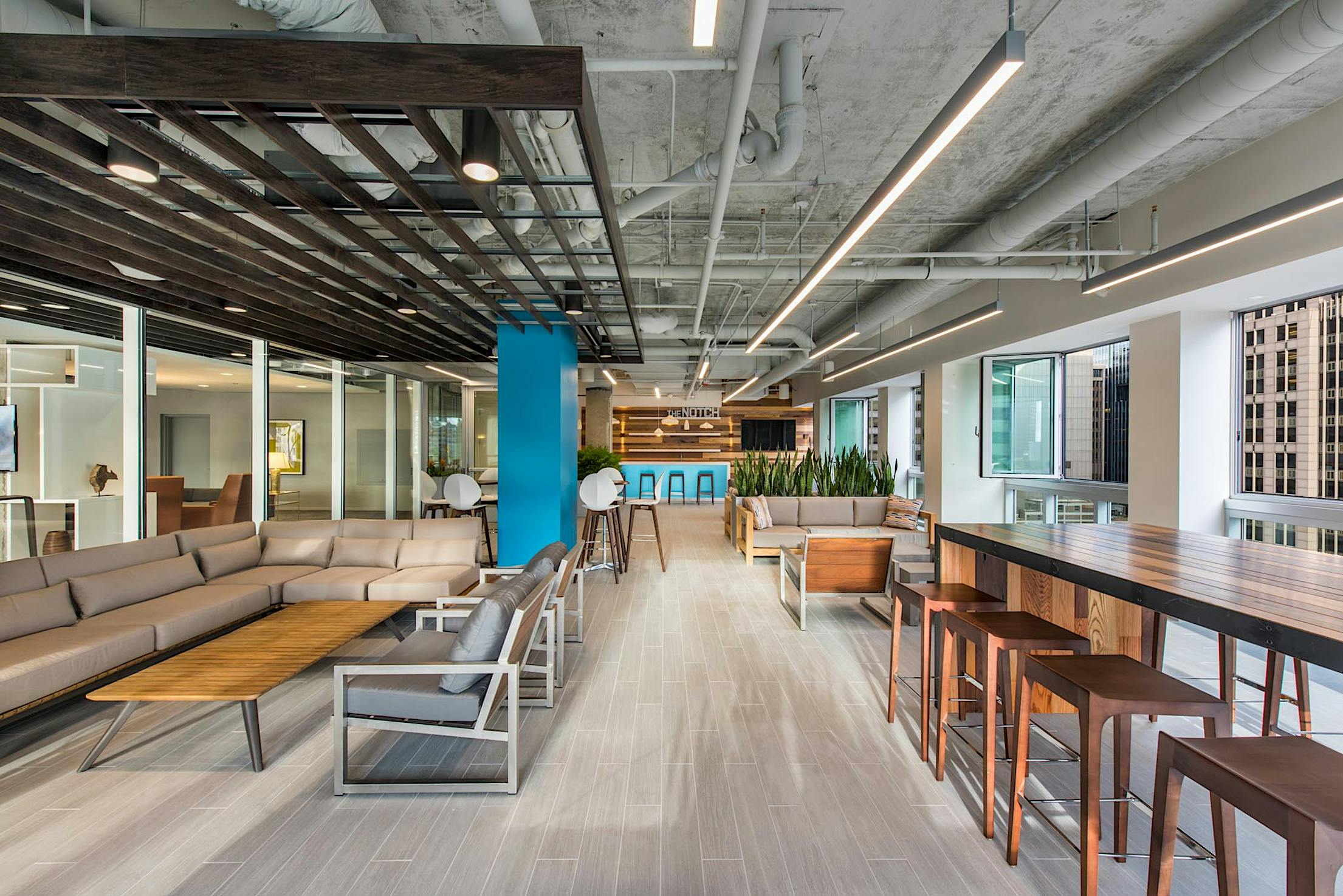 the notch amenities room on the 28th floor with folding glass window walls open for fresh air in high-rise office building