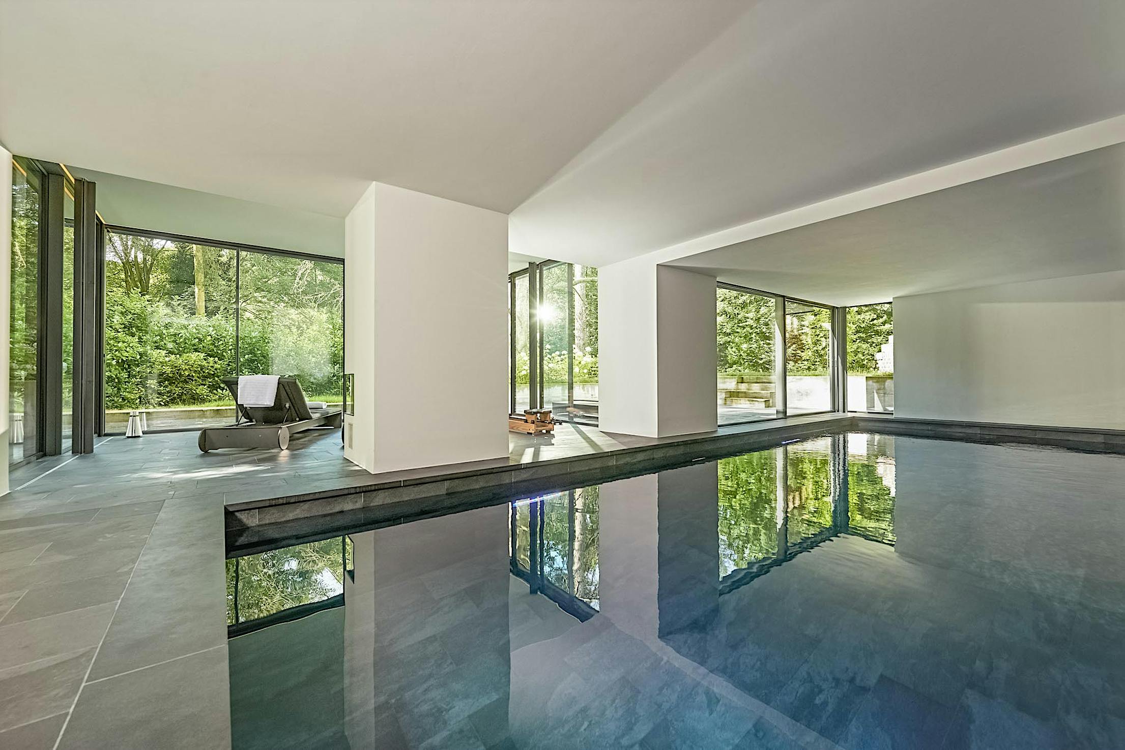 floor to ceiling cero minimal sliding glass walls in pool house