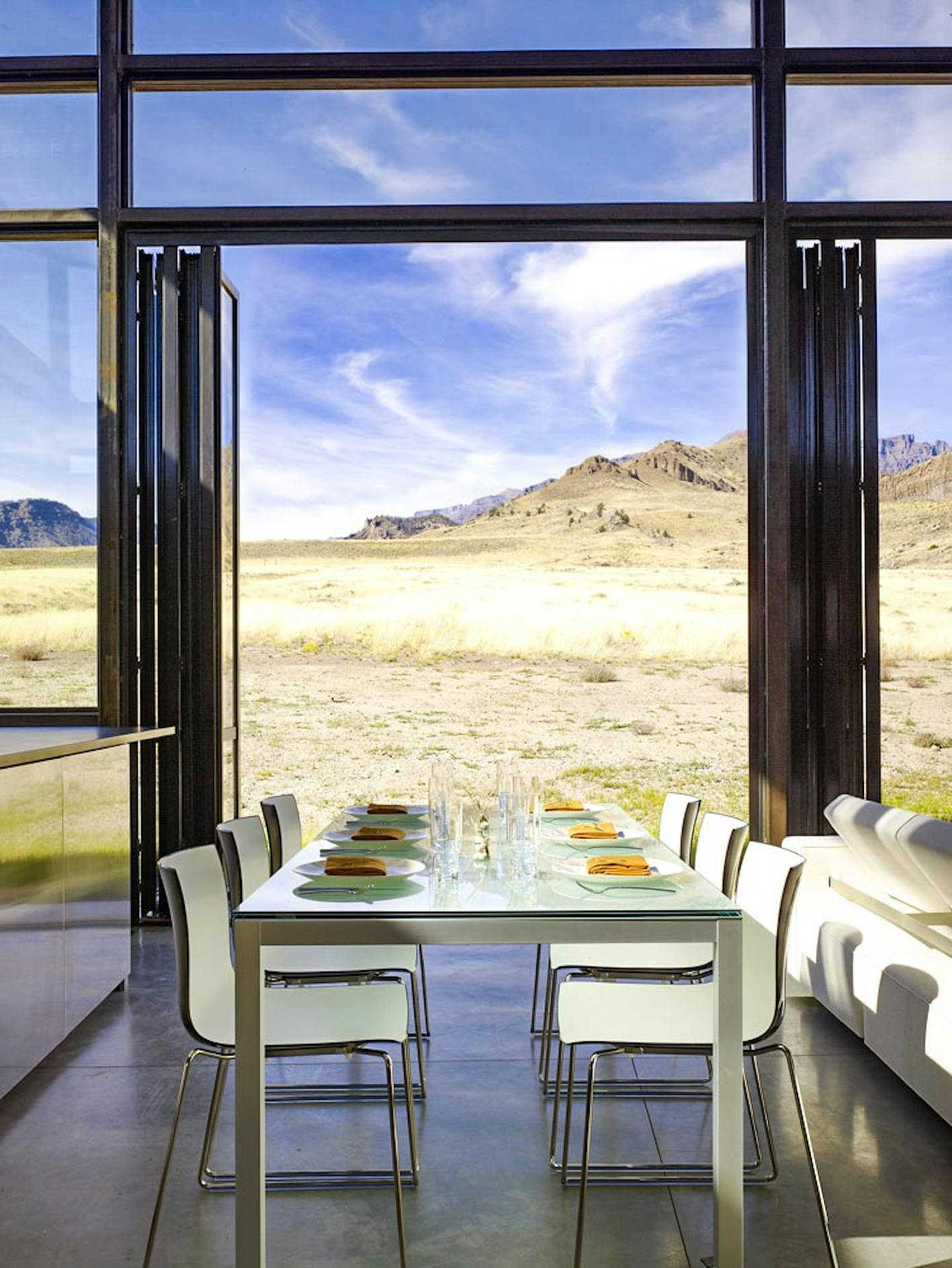 open view of nature out of folding glass wall in dining room