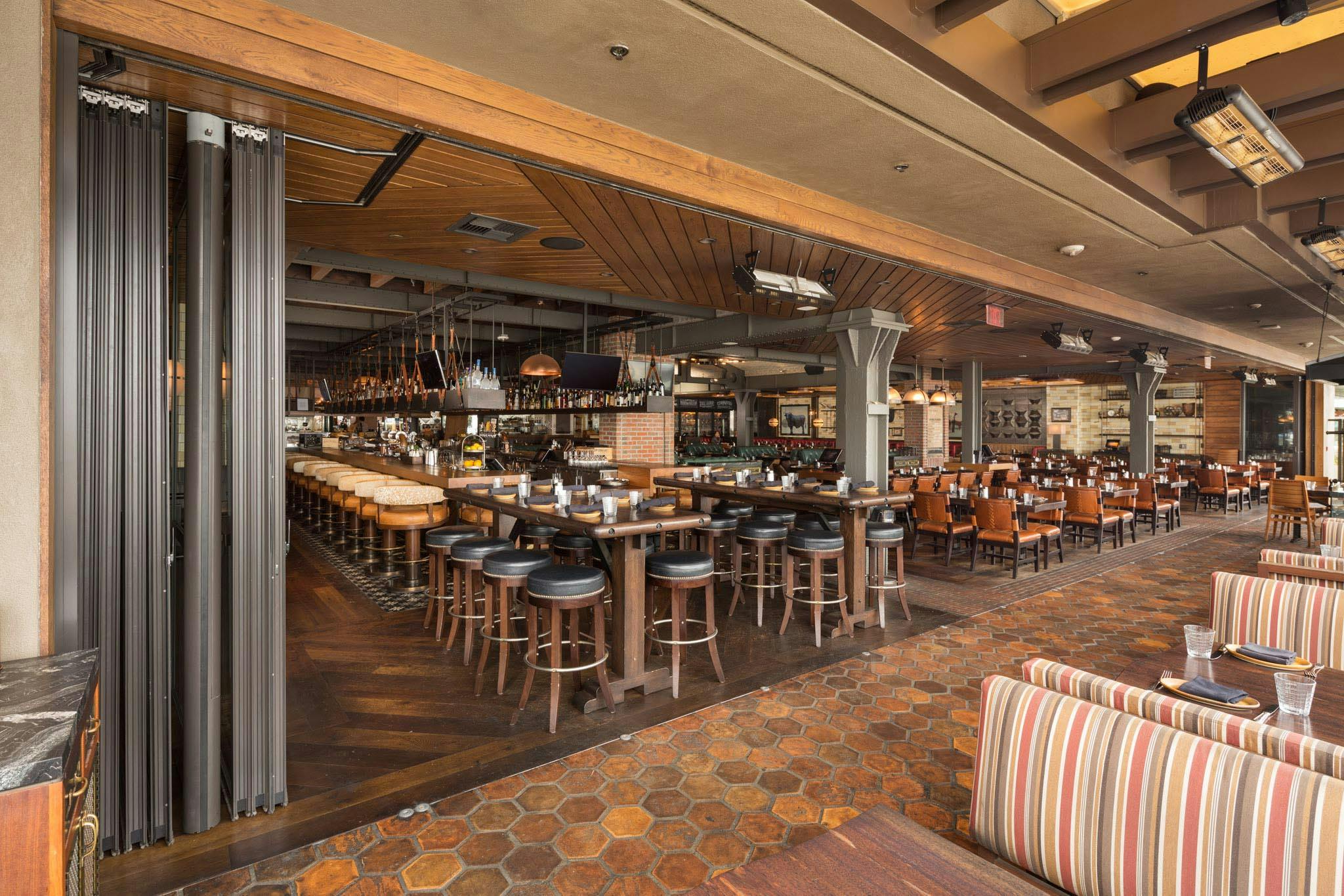 sliding glass wall in restaurant opening to patio for fresh air and views