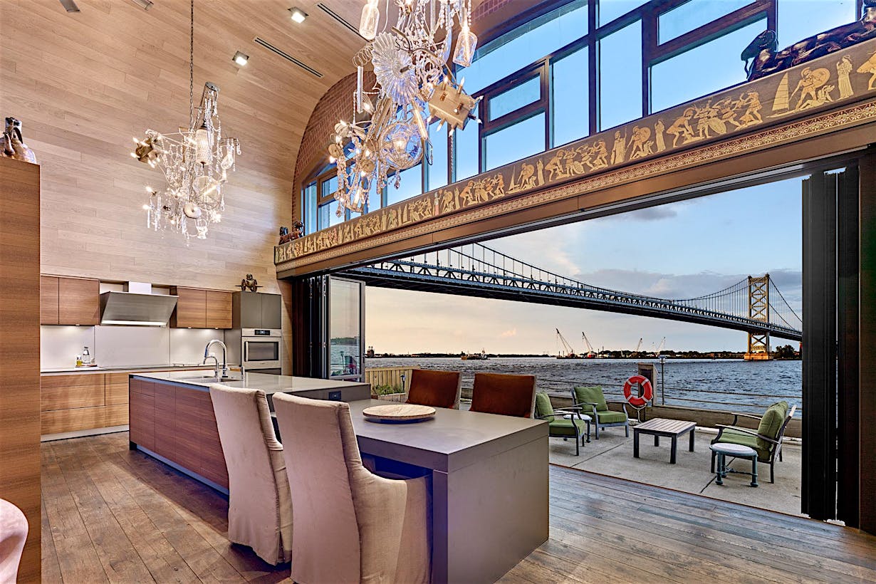 grand philadelphia kitchen with bridge view through opening glass wall