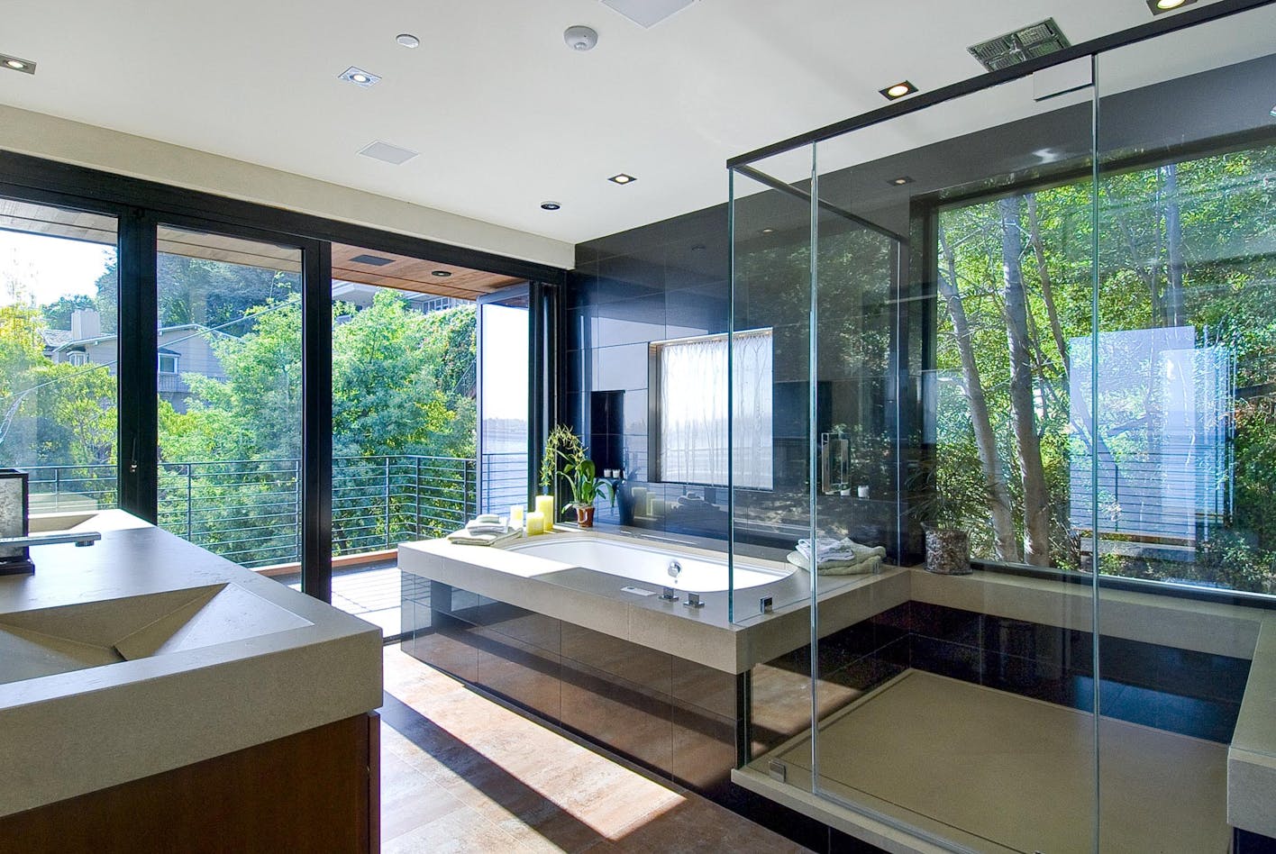 spa-like bathroom with folding glass wall open to freshair and natural daylight
