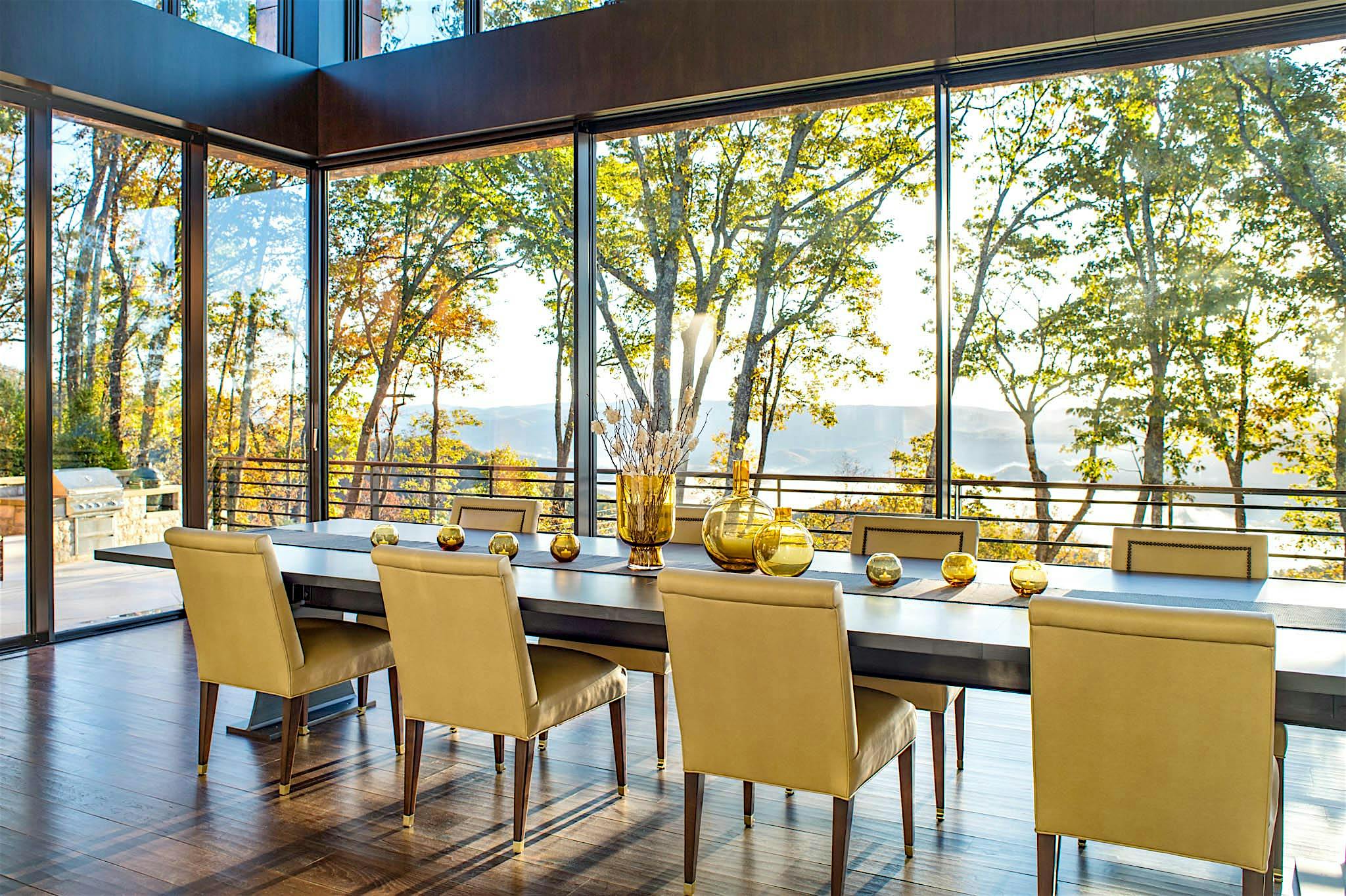 beautiful tree lined view in dining room through cero minimal sliding glass wall