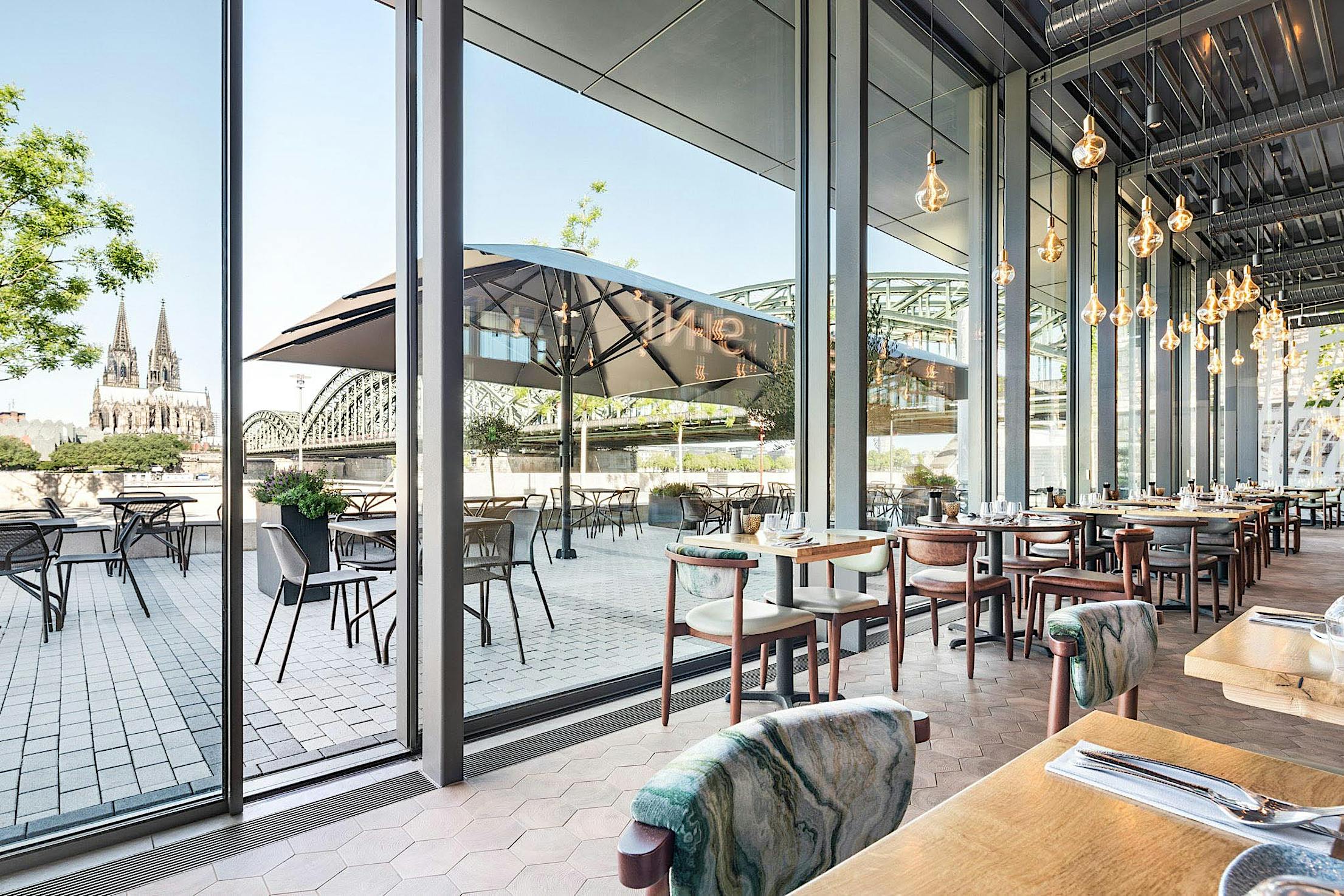 restaurant spaces designed with minimal sliding glass walls for fresh air and daylight