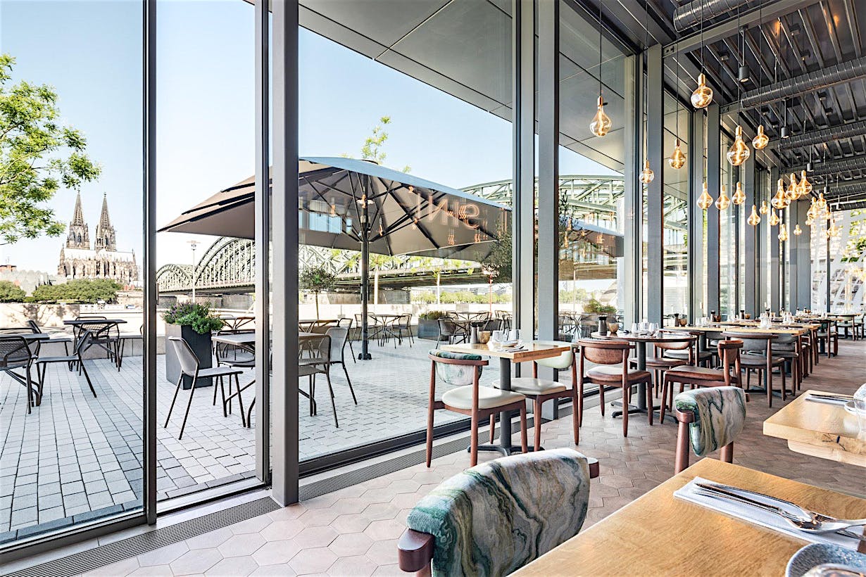 restaurant spaces designed with minimal sliding glass walls for fresh air and daylight