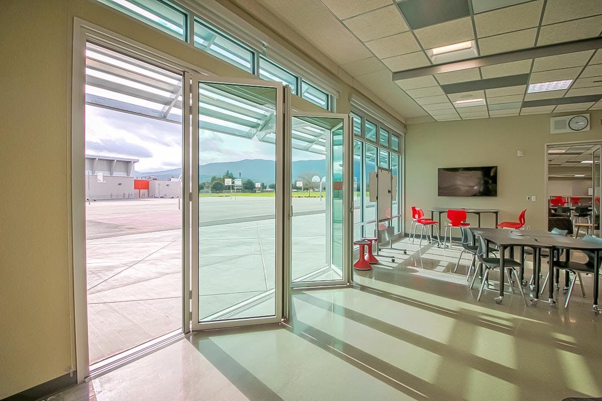 modular school buildings open to outside with folding glass wall