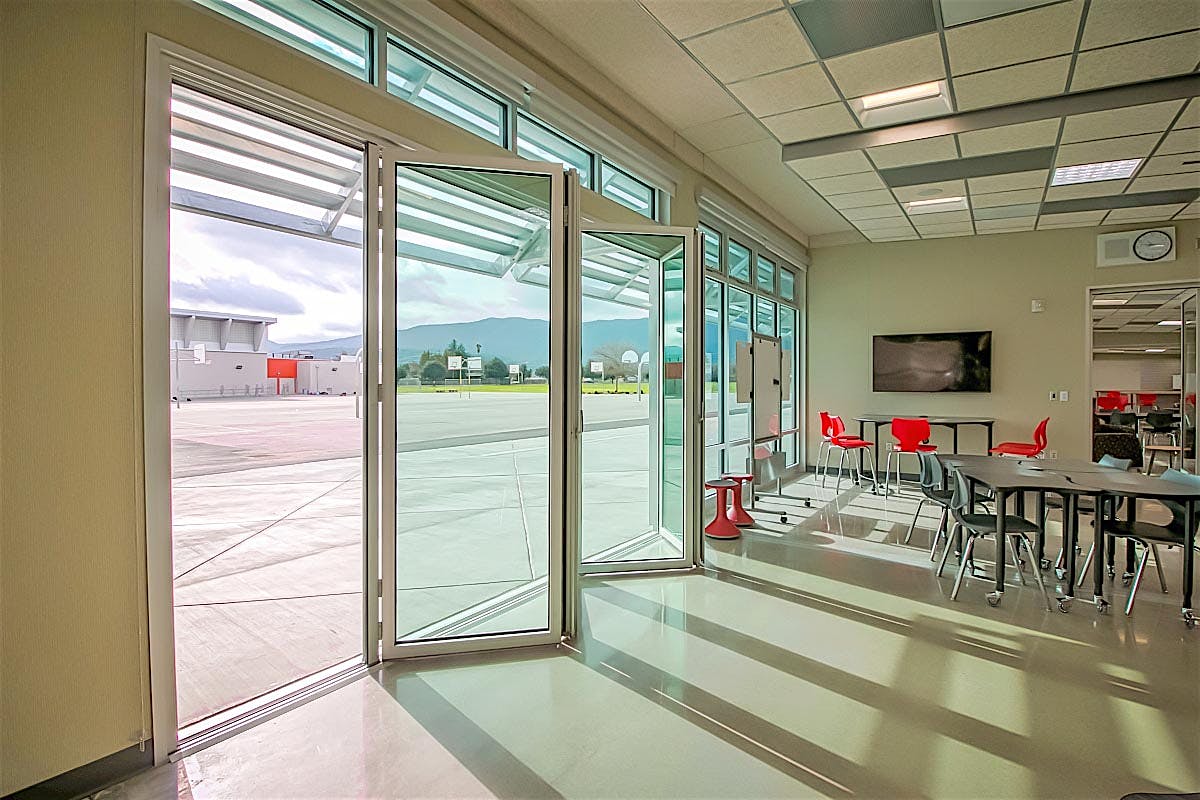 modular school buildings open to outside with folding glass wall