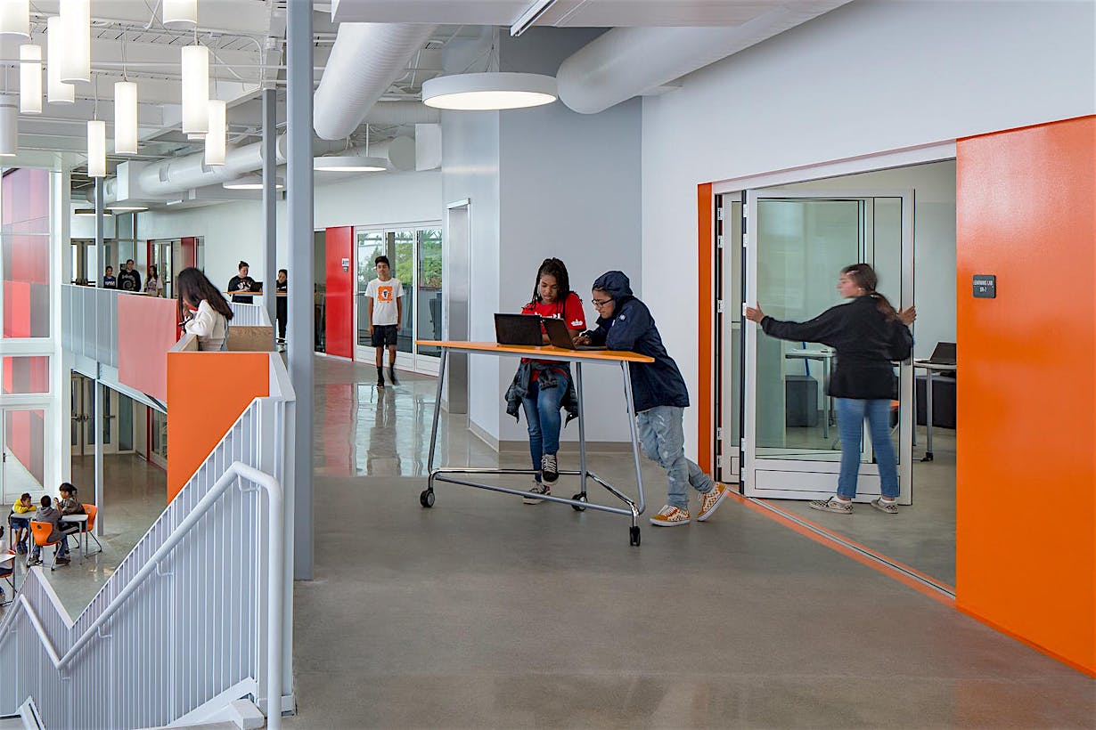 student opporating folding door in one of the  21st century classrooms at rio del sol academy