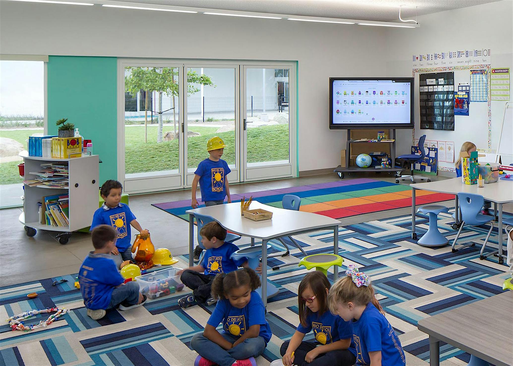 learning hub in 21st Century Classroon Design with opening glass walls and children collaborating