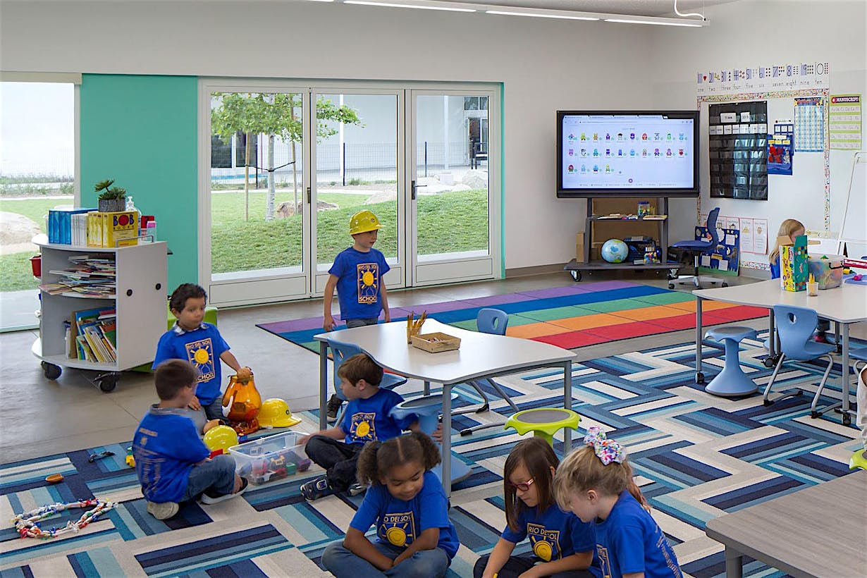 learning hub in 21st Century Classroon Design with opening glass walls and children collaborating