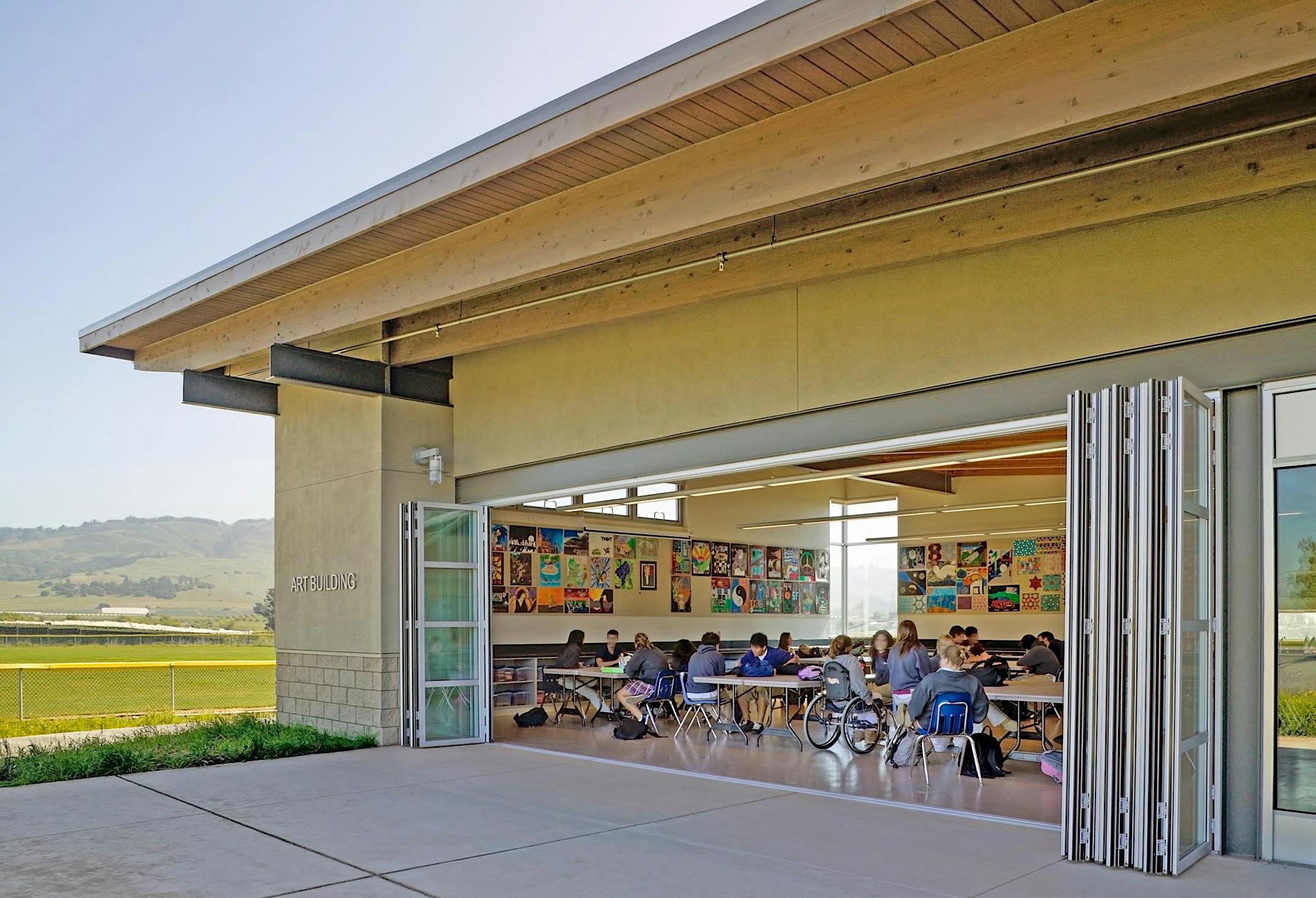 high school classroom with large oping folding wall letting in fresh air and daylight