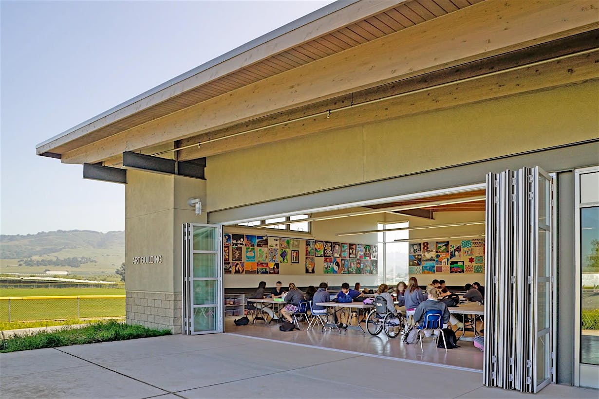 high school classroom with large oping folding wall letting in fresh air and daylight