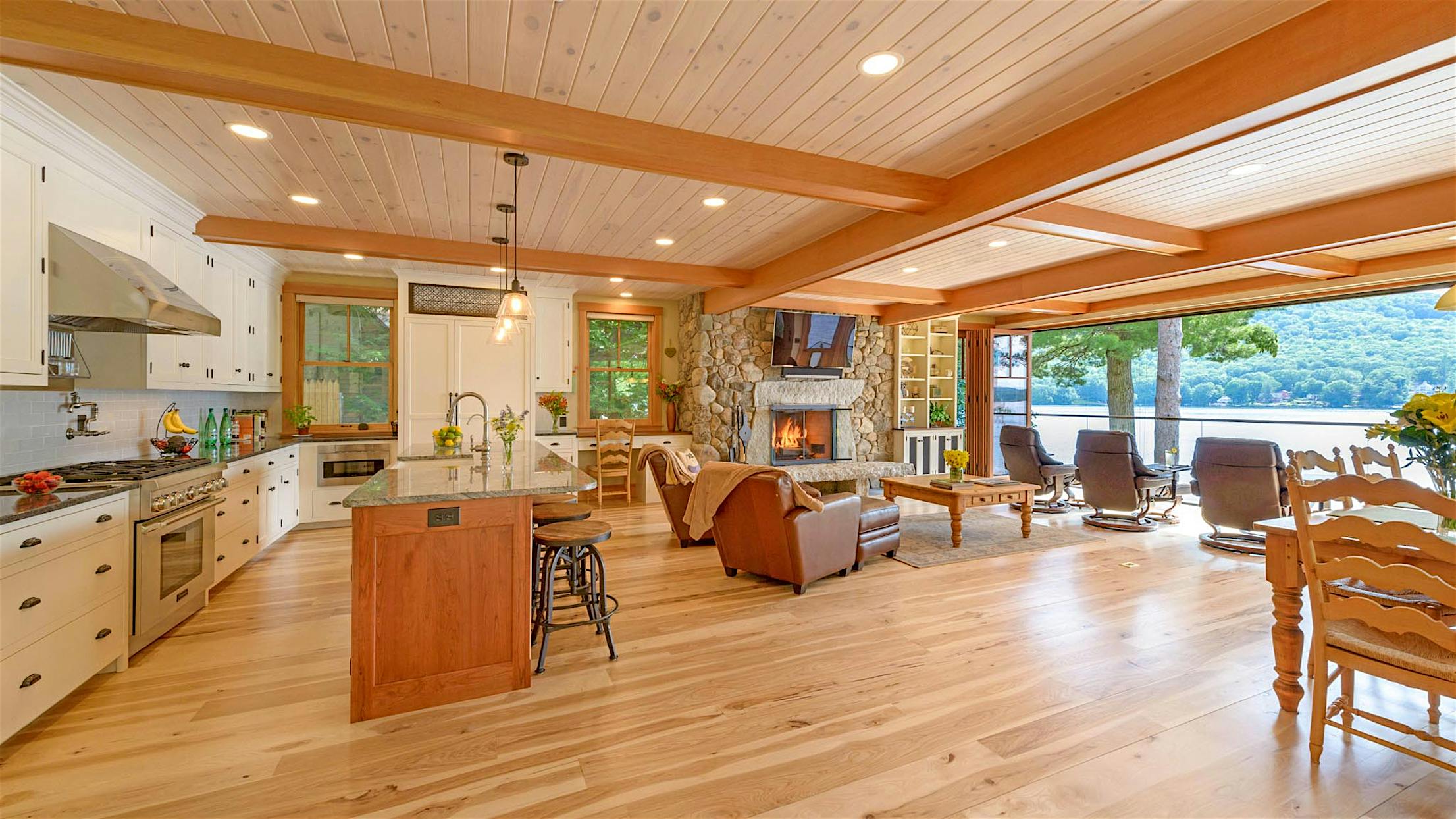 lakefront living room remodel with wood framed bifold door and view