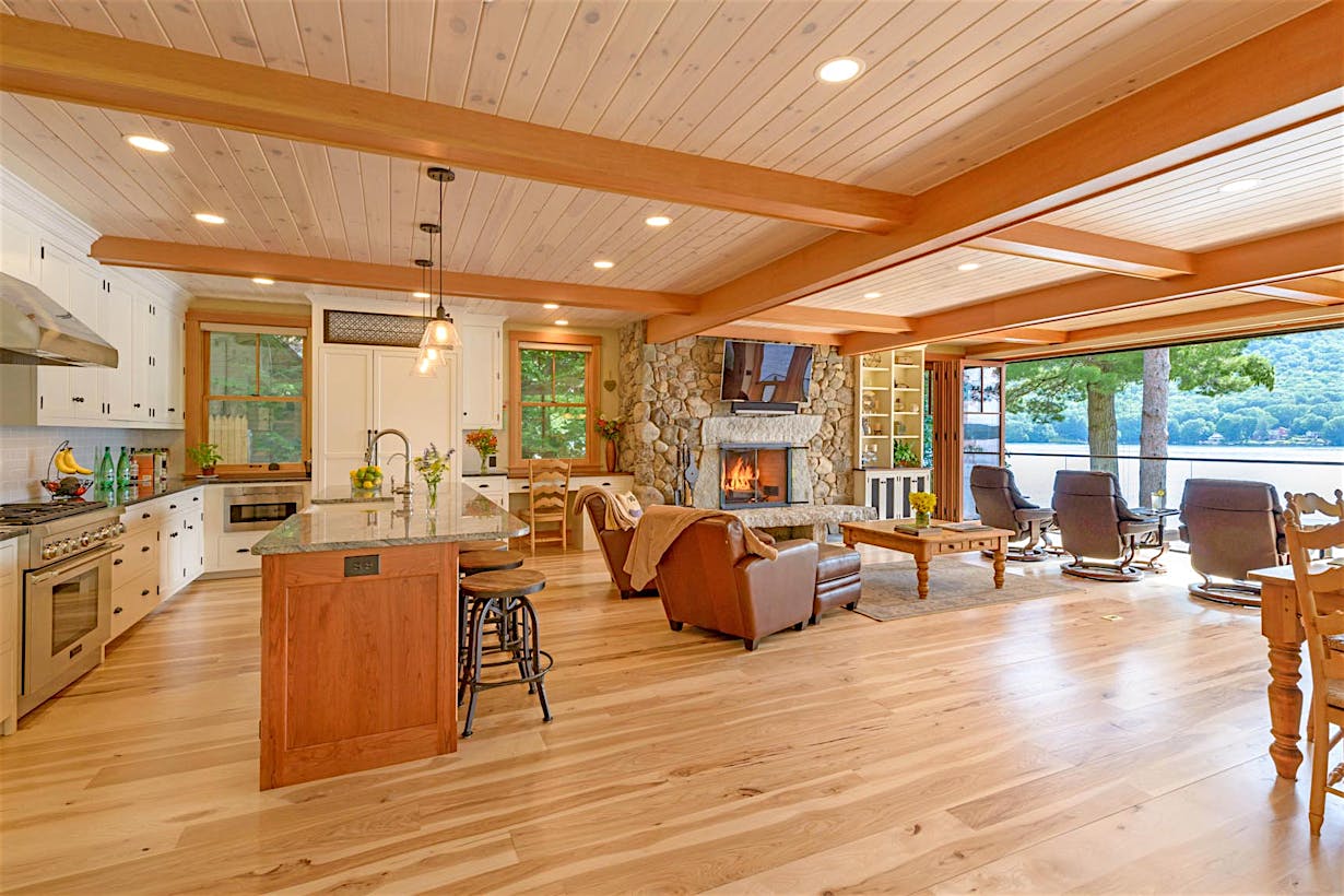lakefront living room remodel with wood framed bifold door and view