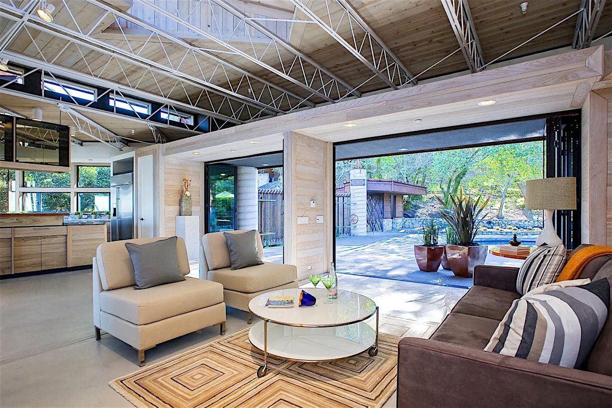 Living room remodel inspiration with opening glass wall
