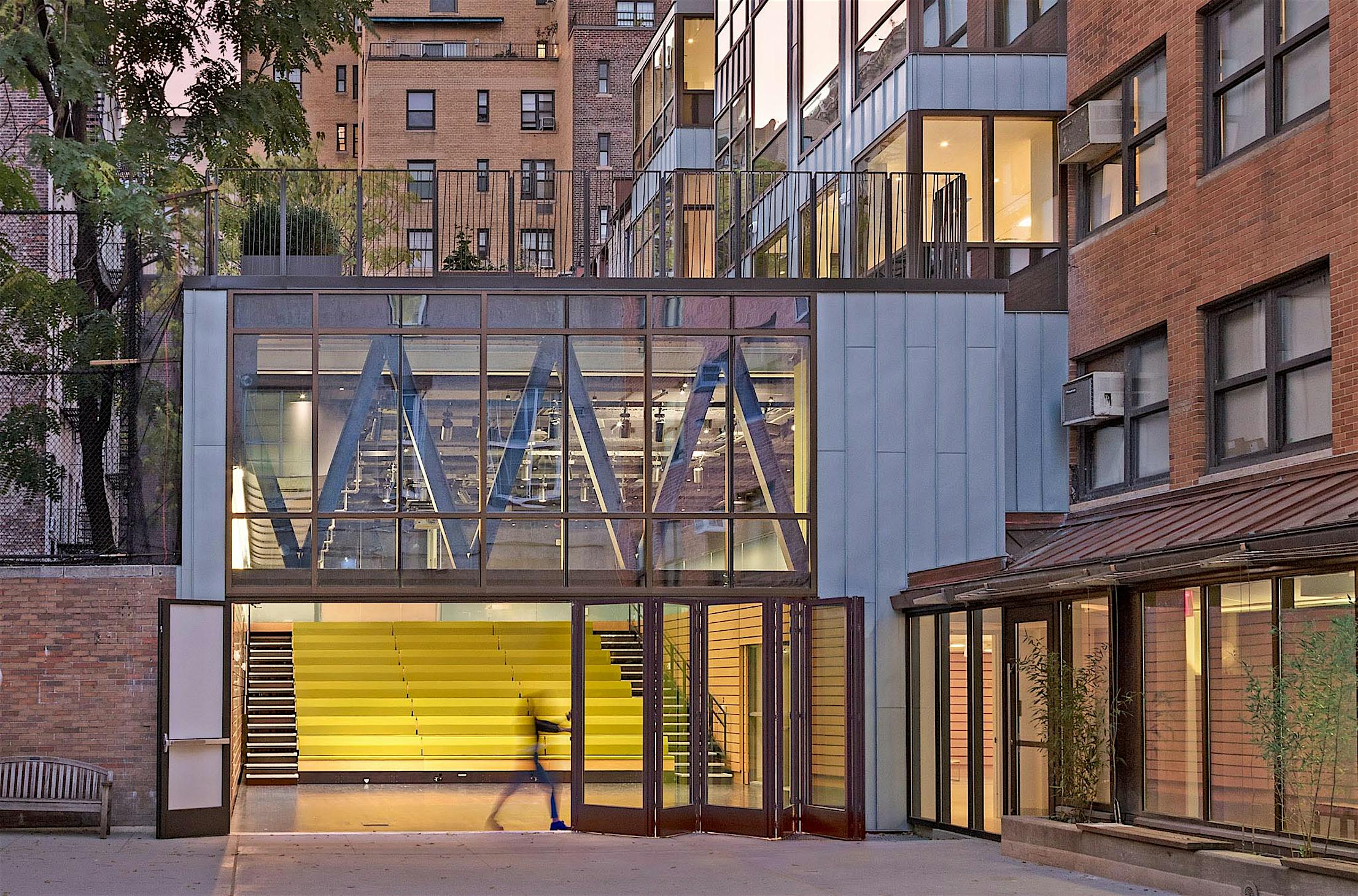 teacher opening folding glass wall in 21st century school design