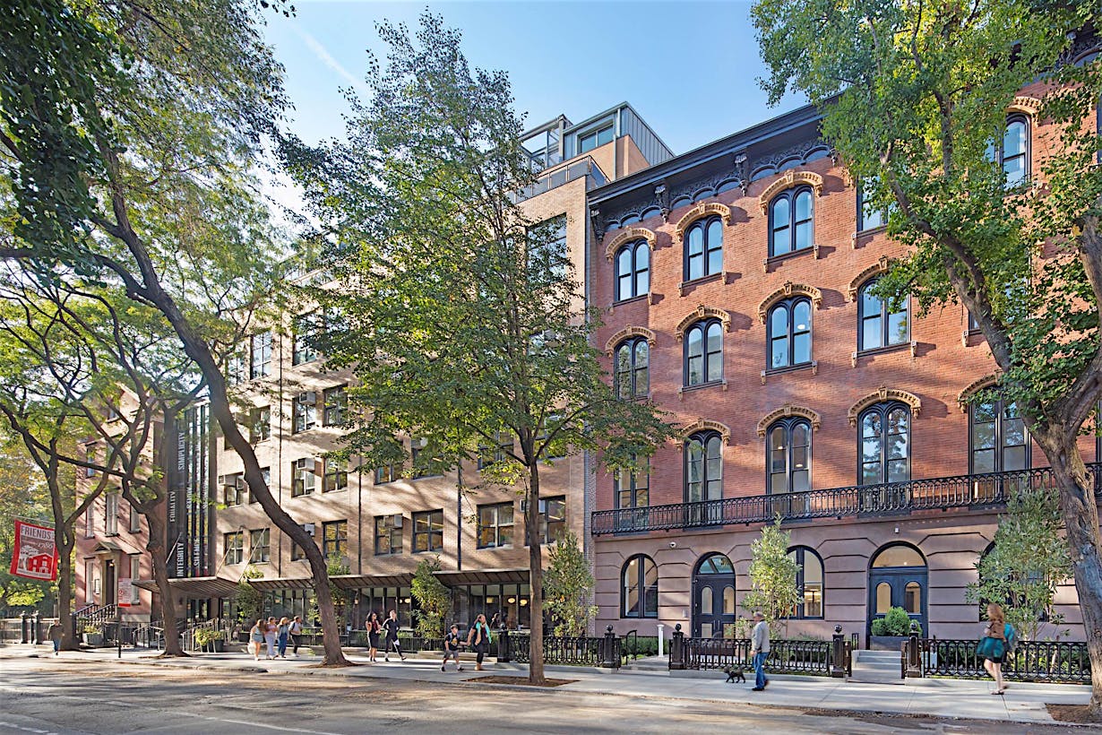 historic brownstones in NYC with modern school design with folding glass walls