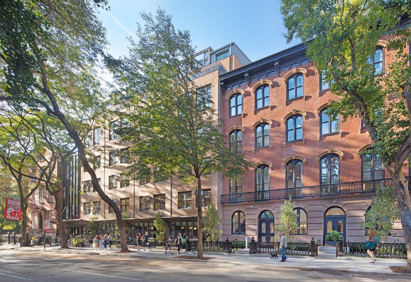 historic brownstones in NYC with modern school design with folding glass walls