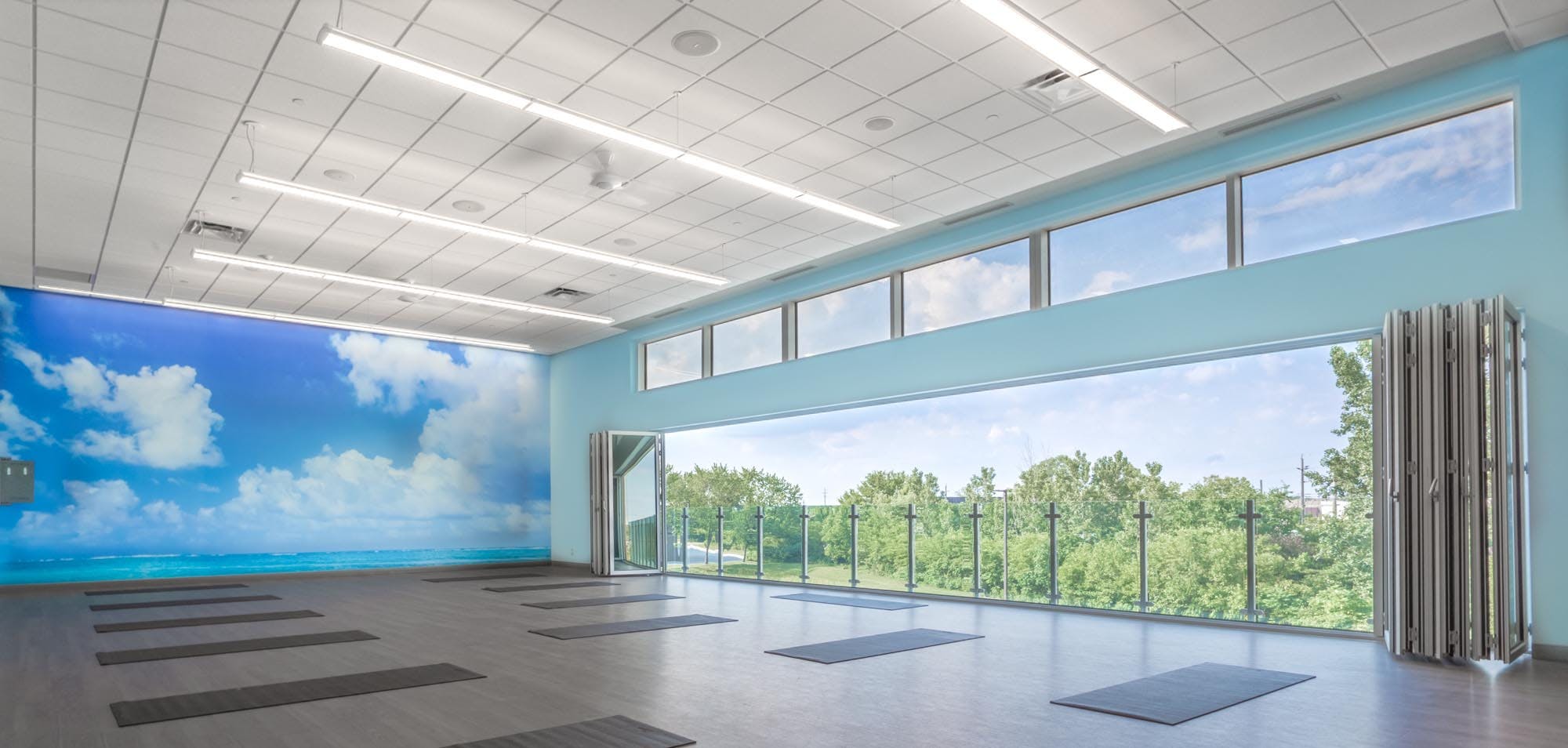 Fitness center design for health and wellness with opening glass walls