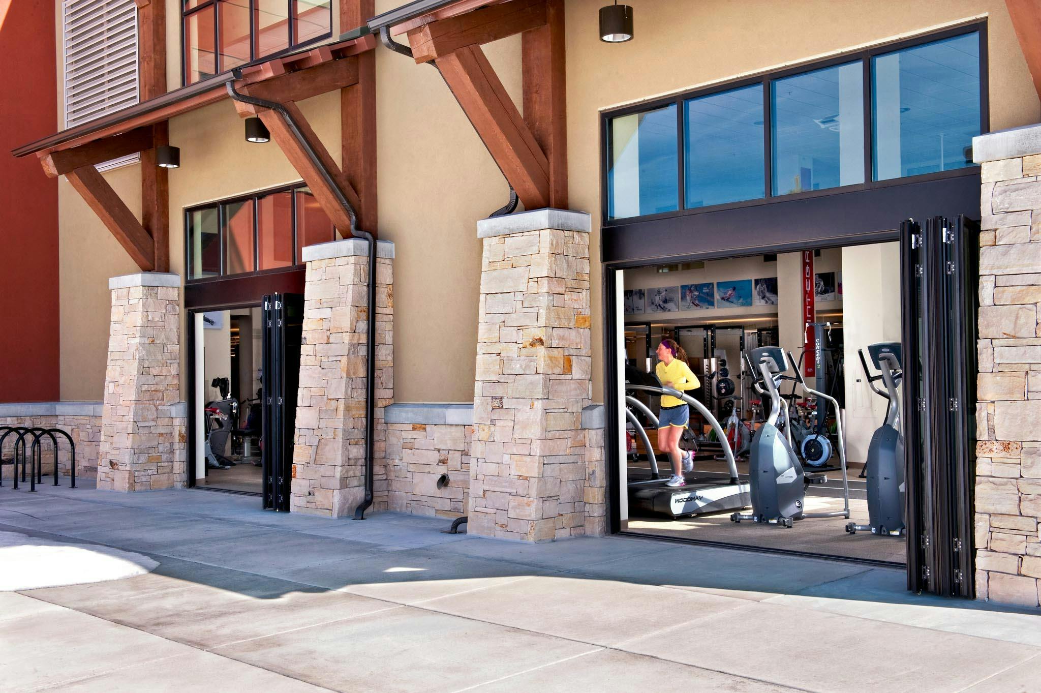 fitness center designed with folding glass walls for fresh air, light, and views