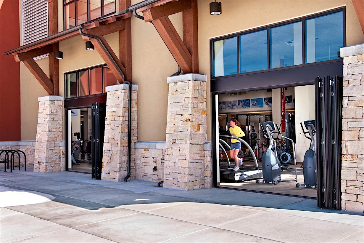 fitness center designed with folding glass walls for fresh air, light, and views
