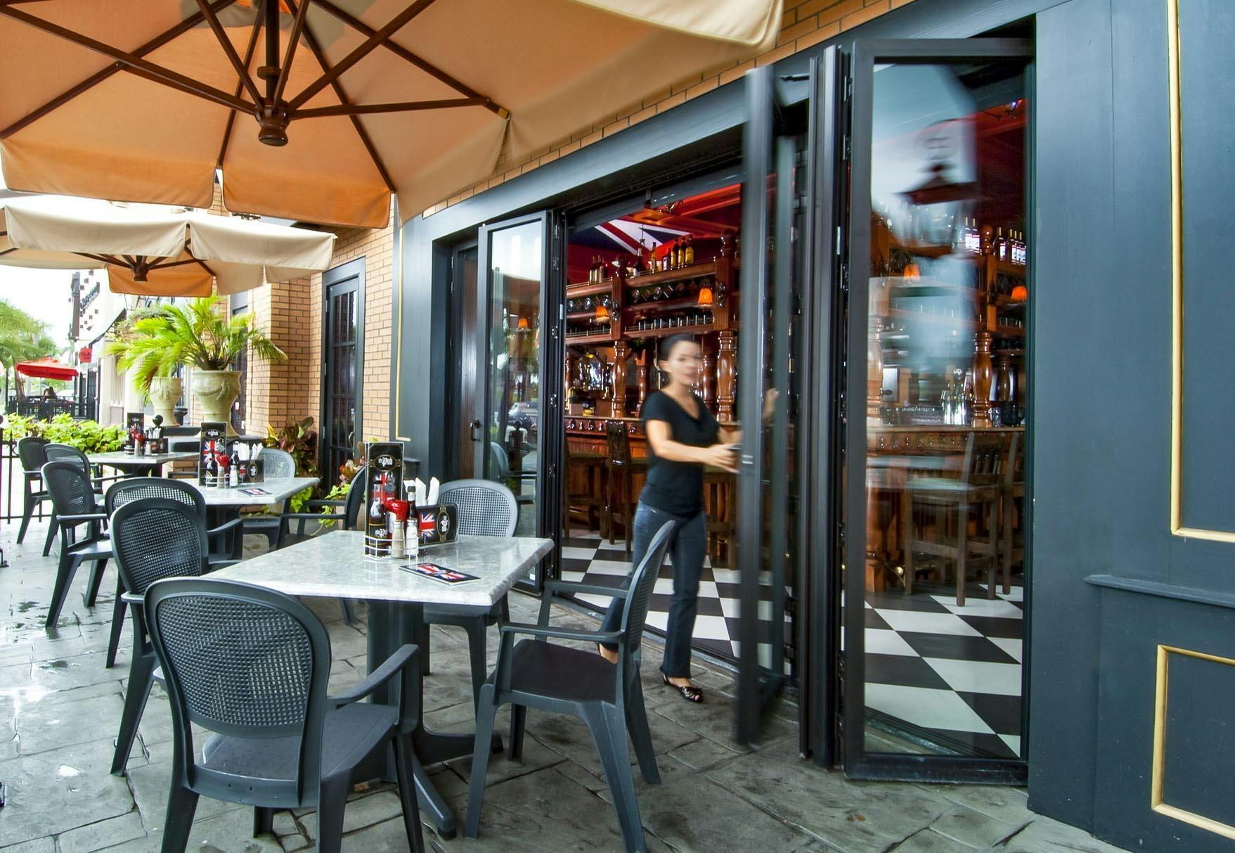 outdoor dining on sidewalk with commercial moving glass wall