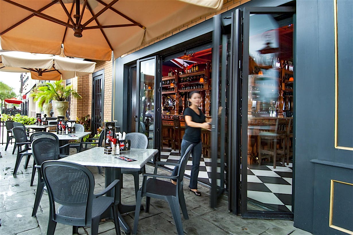 outdoor dining on sidewalk with commercial moving glass wall