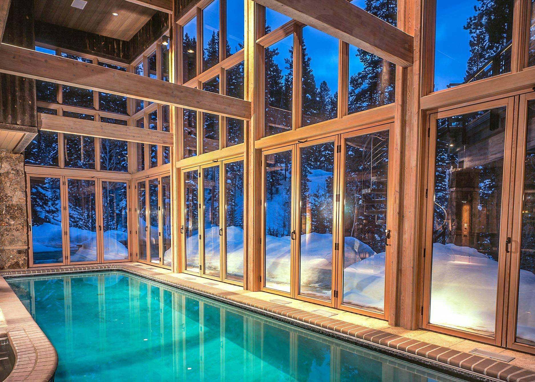 breathtaking winter getaway pool house with operable glass walls