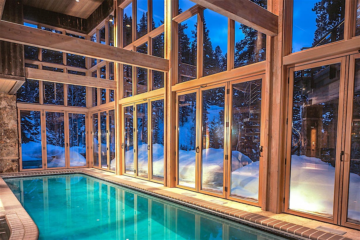 breathtaking winter getaway pool house with operable glass walls