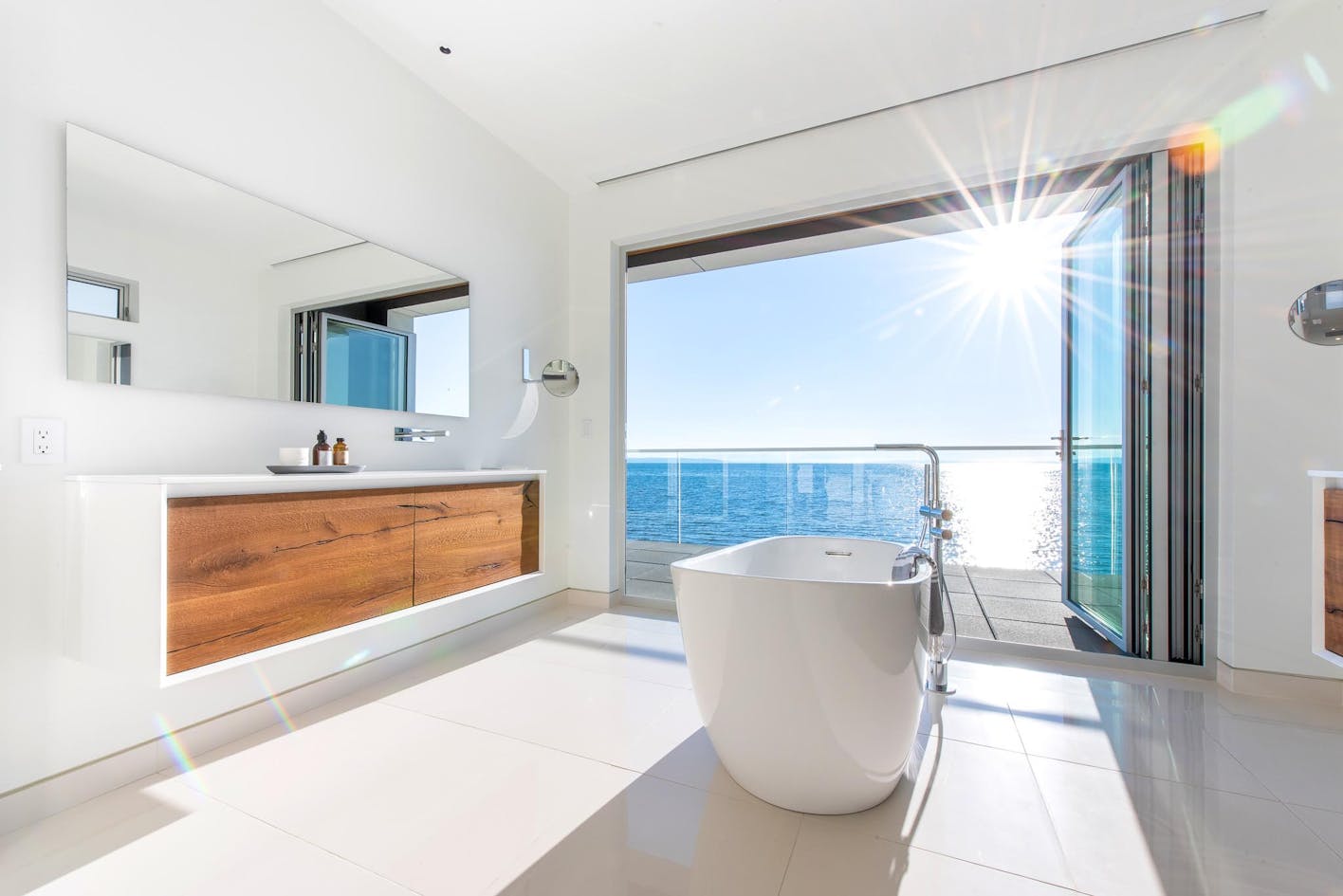 bathroom with a view through exterior moving glass walls