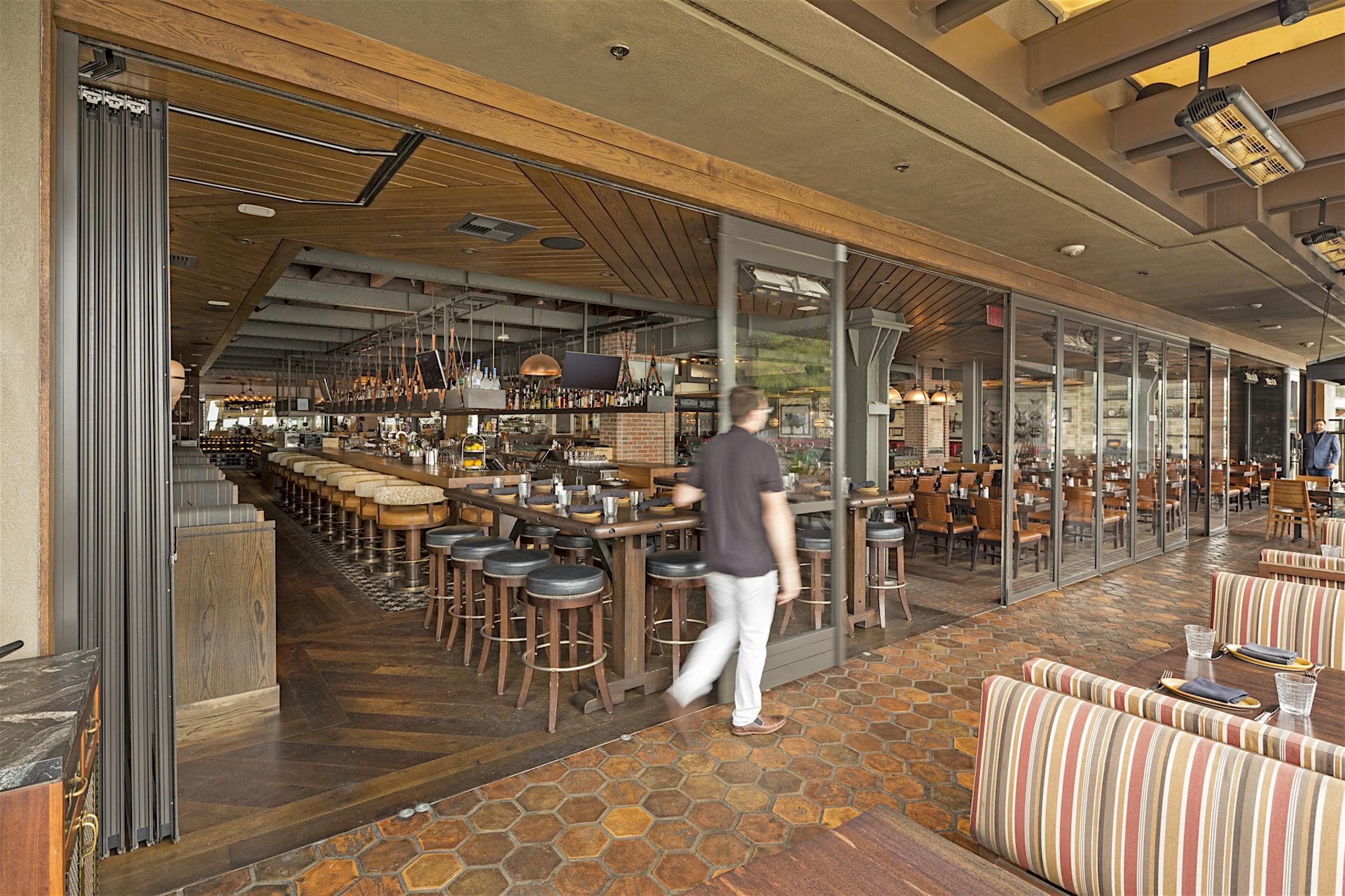 opening the commercial stacking glass doors at a restaurant