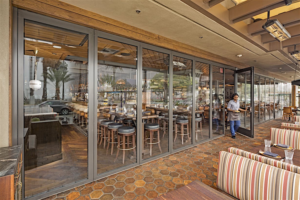 integrated swing door in stacking glass door system for easy access