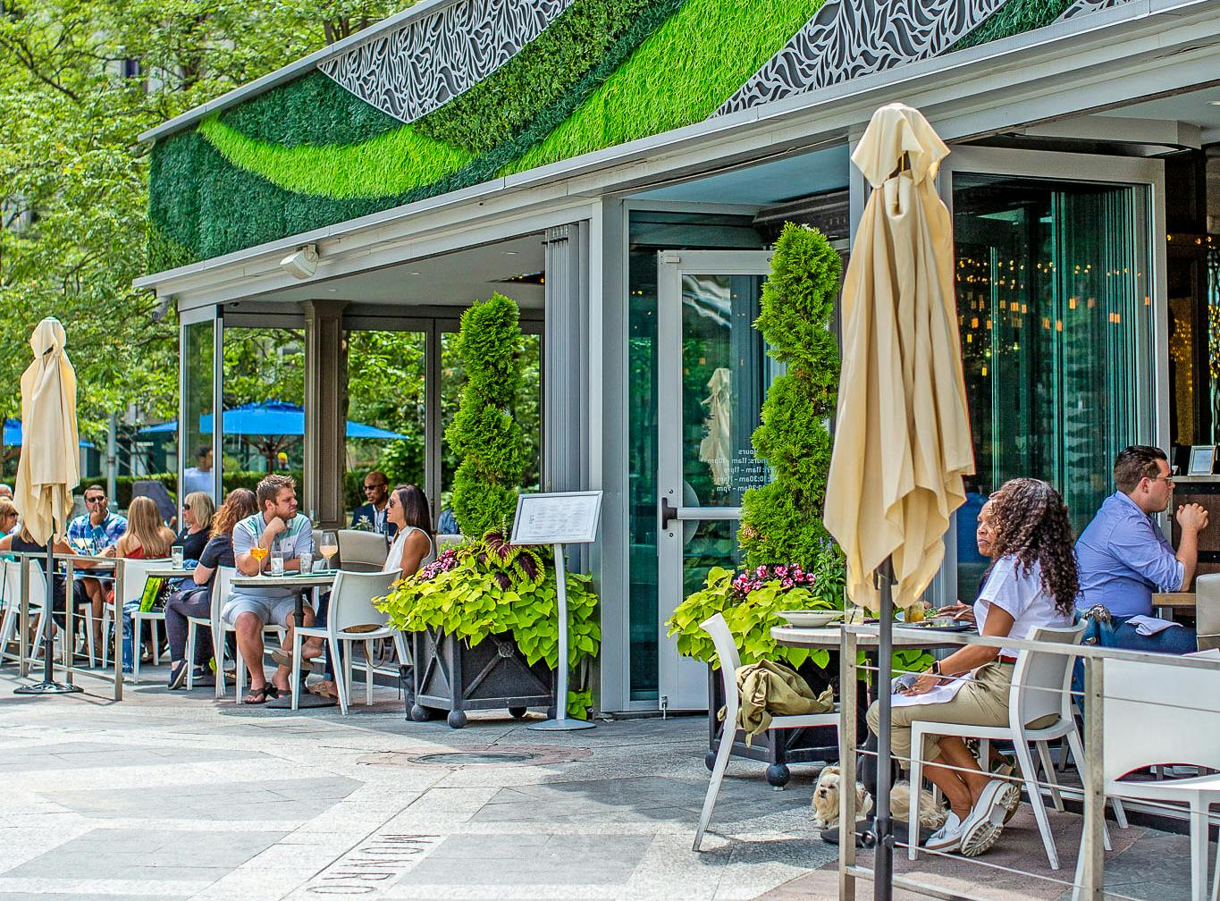 indoor outdoor restaurant with exterior sliding glass walls attracts customers