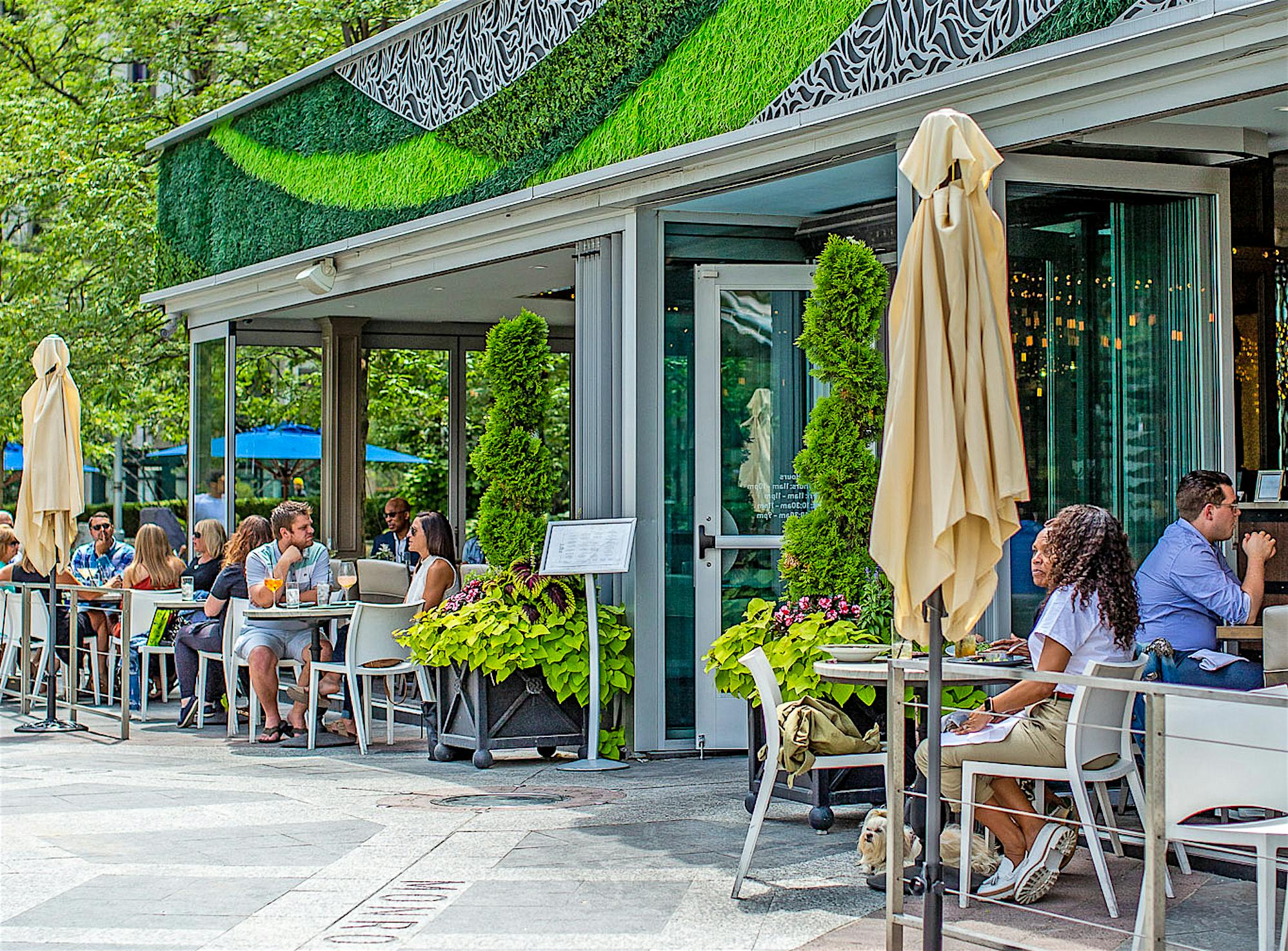 indoor outdoor restaurant with exterior stacking glass doors attracts customers