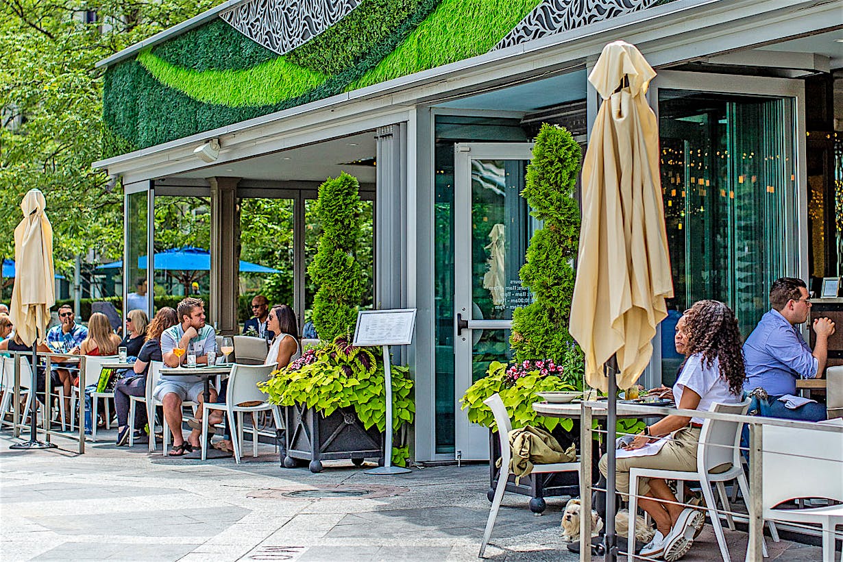 indoor outdoor restaurant with exterior stacking glass doors attracts customers
