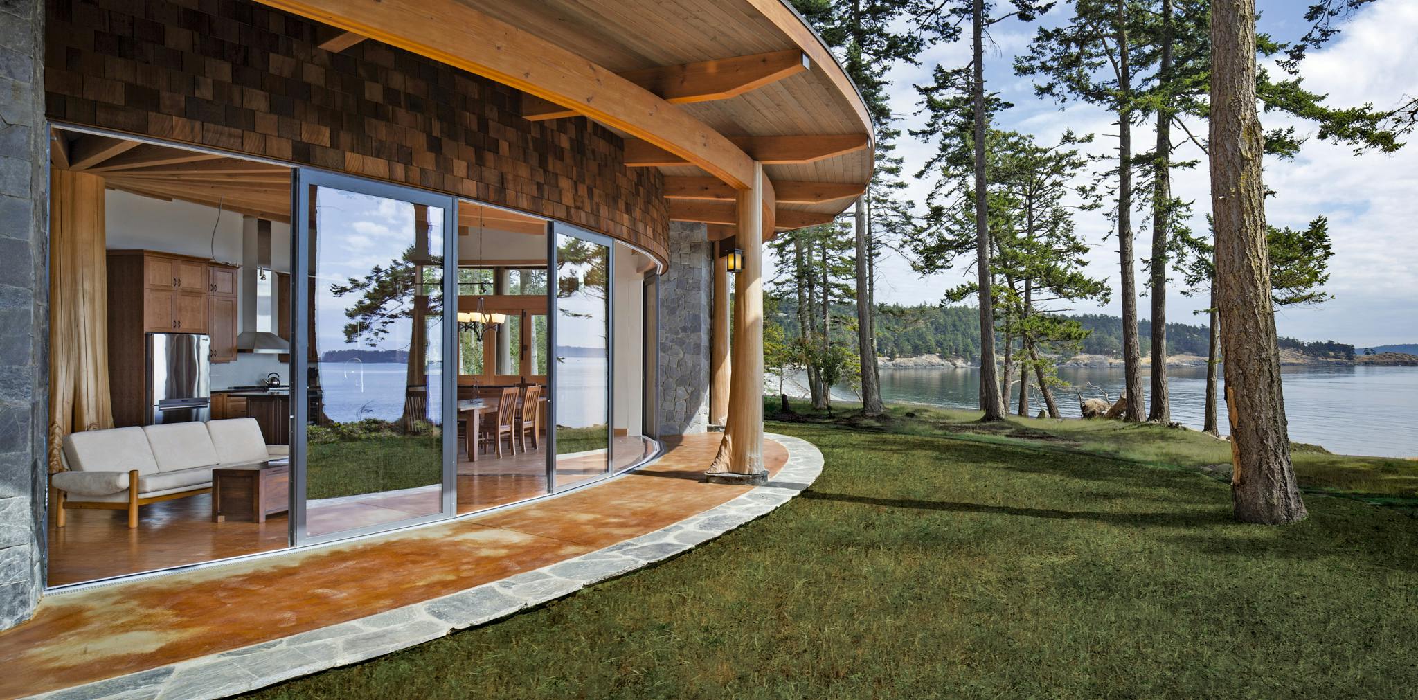 curved sliding glass door system in a waterfront home