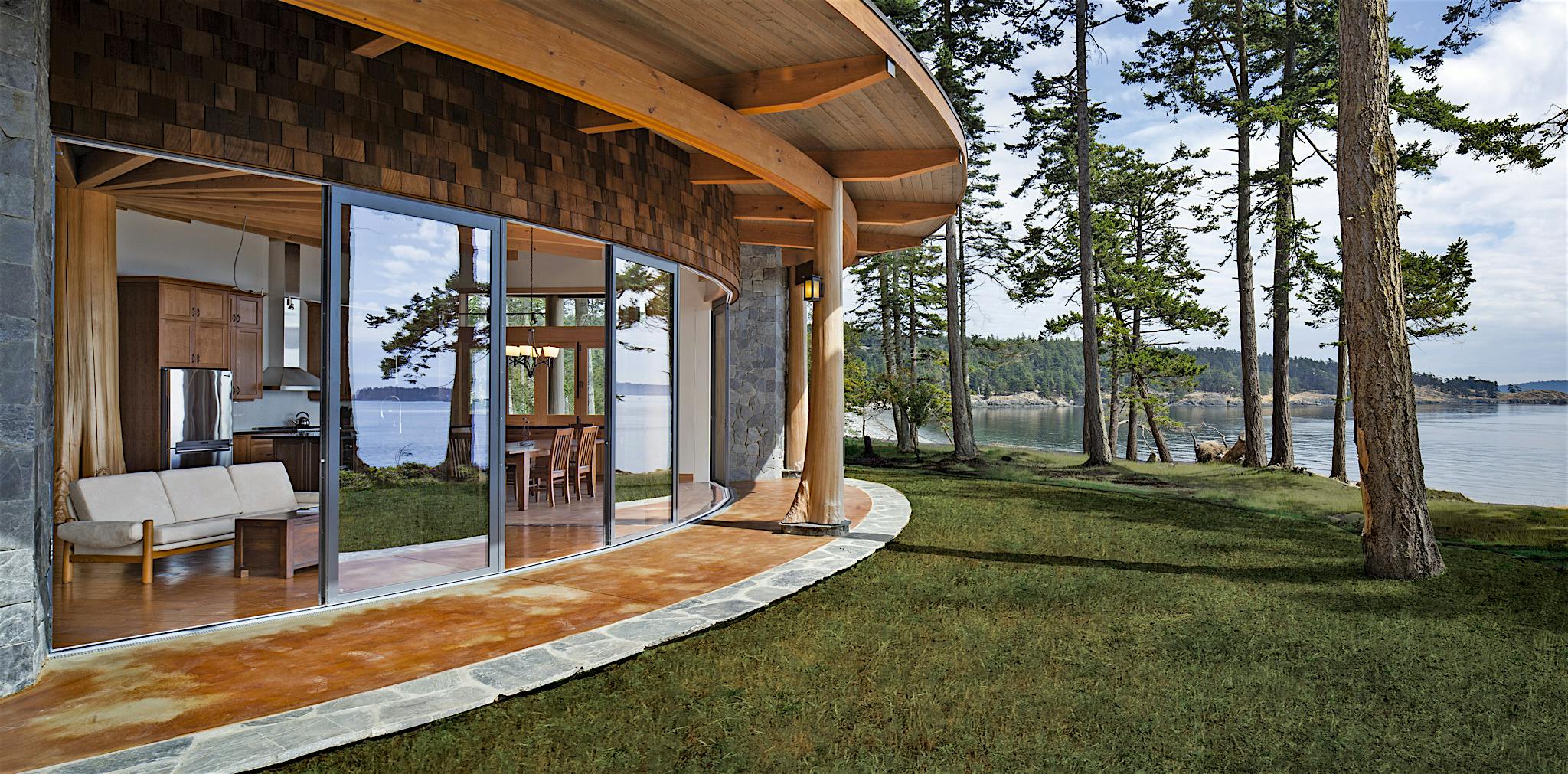 curved sliding glass door system in a waterfront home